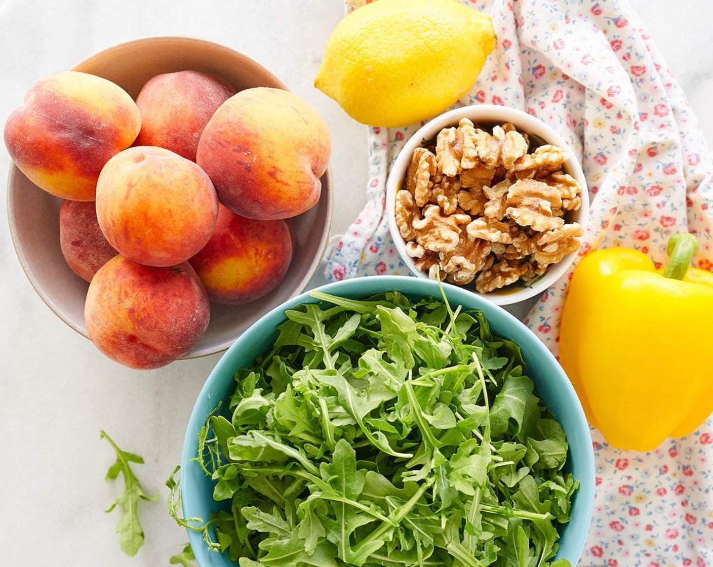 step 1 Place Arugula (8 cups) in large salad bowl. Top with sliced Peaches (6), Crumbled Feta Cheese (1/4 cup) and Walnut (1/2 cup).