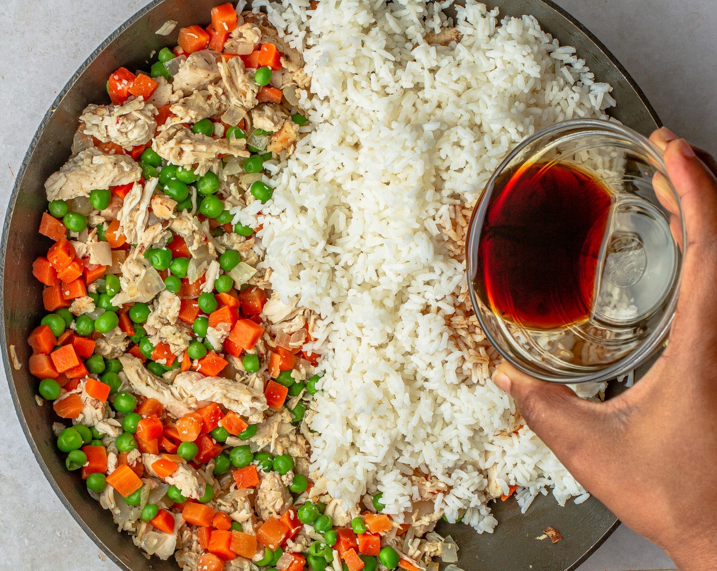 step 3 Fold in the cooked White Rice (1 1/3 cups) and Light Soy Sauce (1/3 cup) and cook for 2 minutes or until the liquid evaporates.