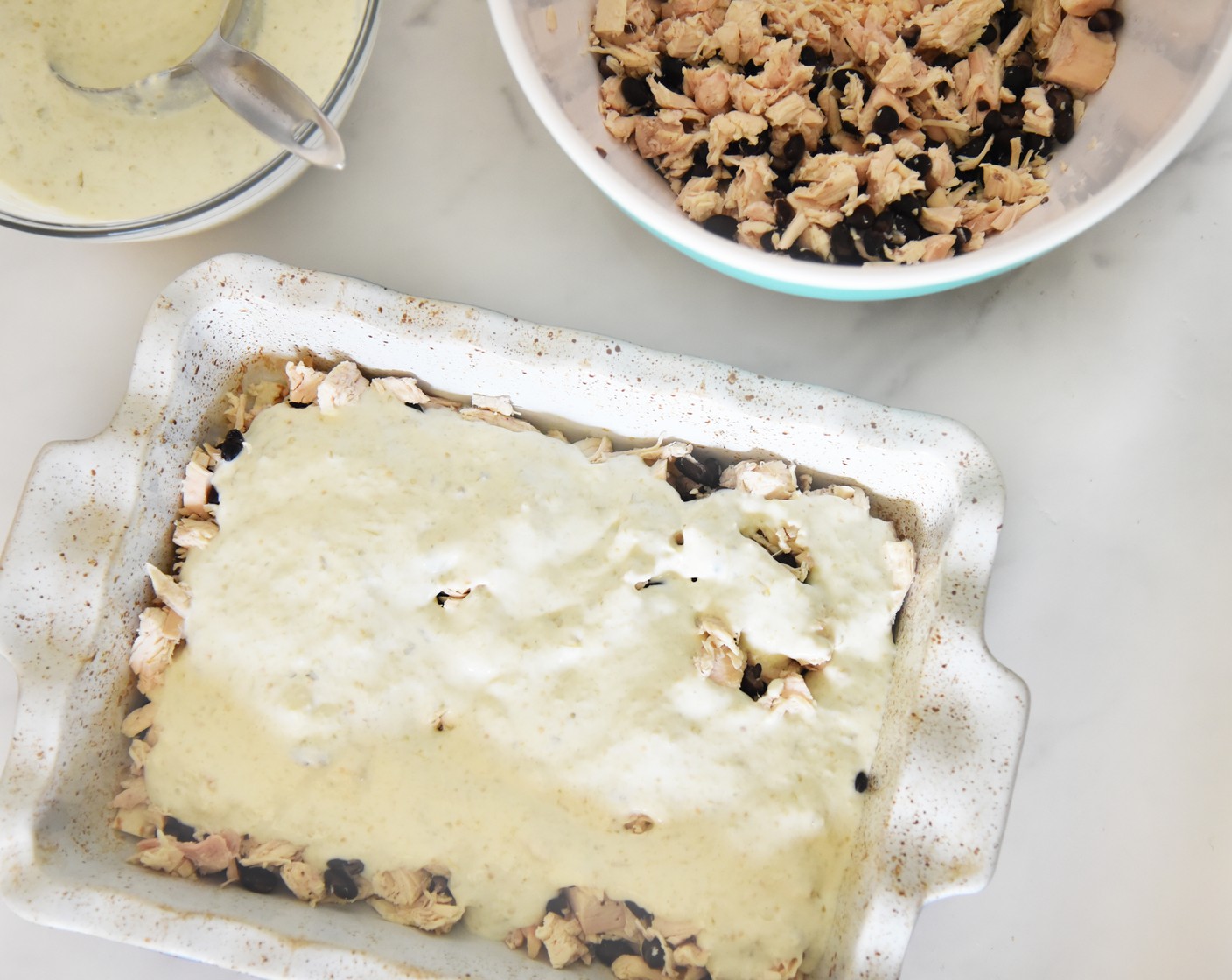 step 6 Spread about 1 cup of the sour cream mixture over the top of the chicken layer.