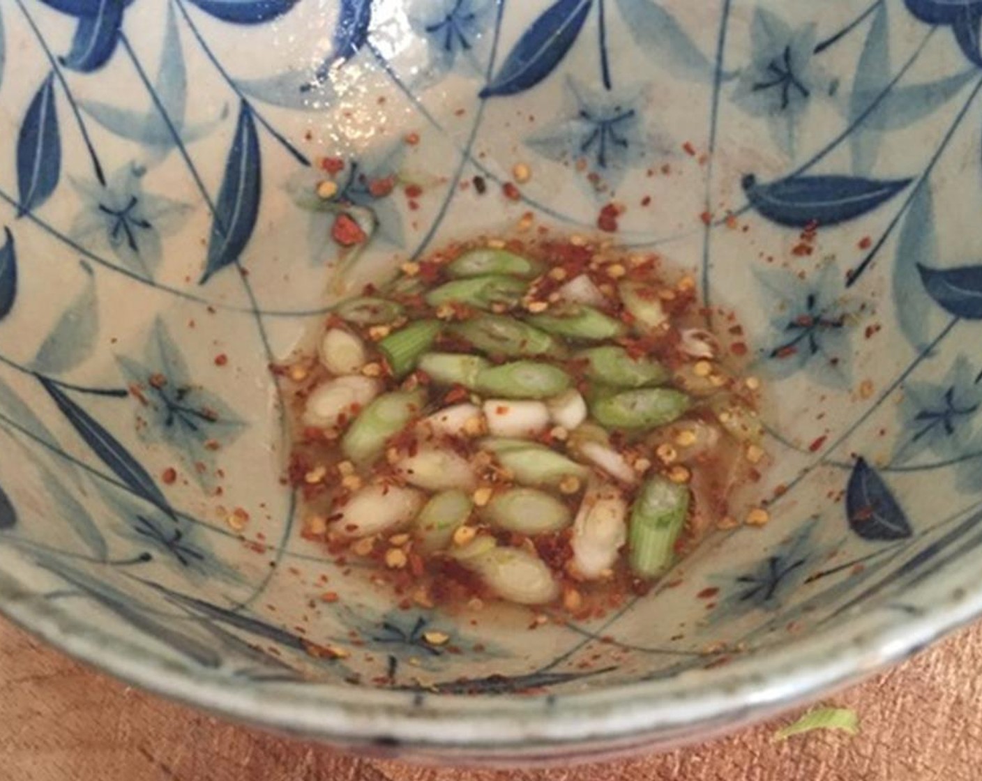 step 2 In a bowl put Fish Sauce (1 Tbsp), Lime (1), Granulated Sugar (1 tsp), and Crushed Red Pepper Flakes (to taste). Stir to dissolve the sugar and then add your sliced Scallion (1 bunch).