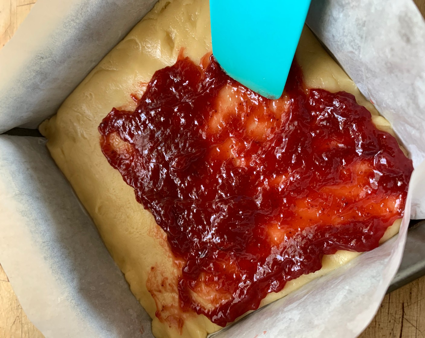 step 4 Spread half of the batter in the bottom of the prepared pan. Using an offset spatula, evenly spread the Just Jan’s® Organic Strawberry Spread (1 cup) on top of the batter.