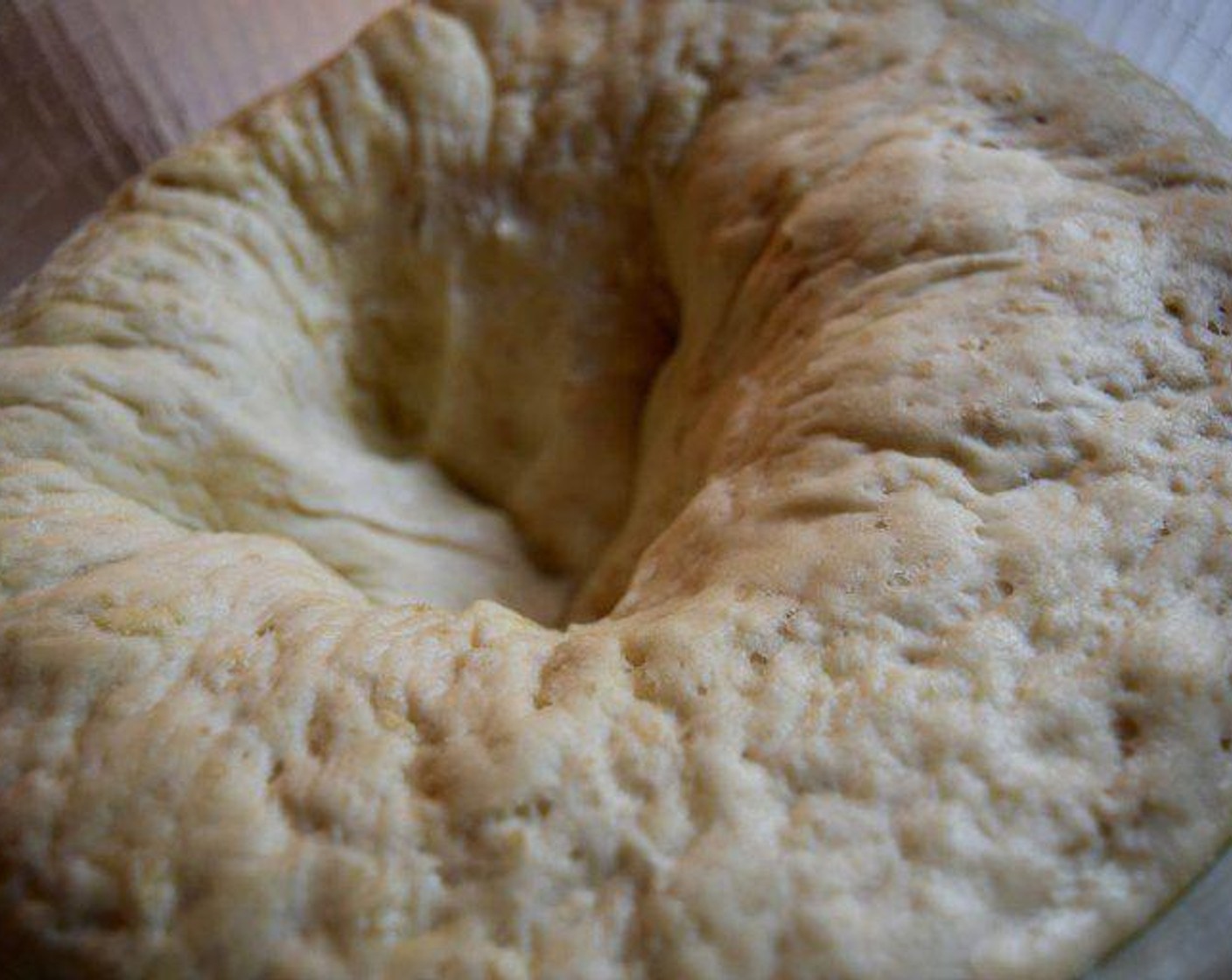 step 7 Set aside the tea towel and punch the dough down.