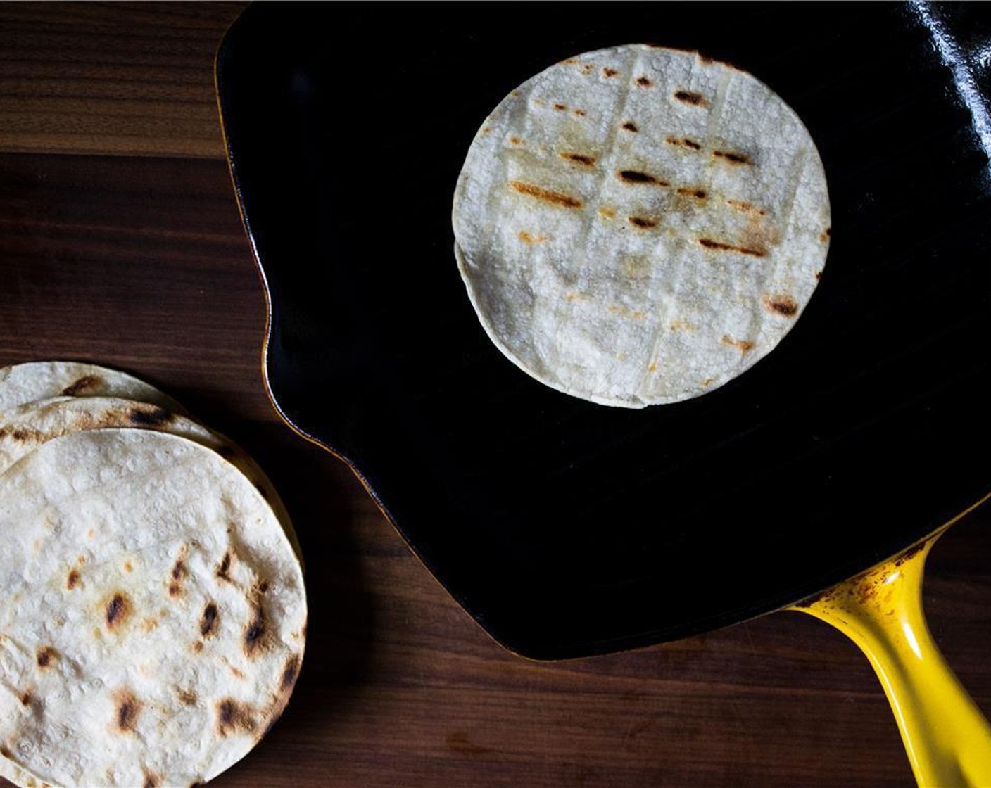 step 7 While the fish marinates, warm the Yellow Corn Tortillas (8) in a grill pan or skillet.  Heat the pan to medium-high heat. Very lightly brush each side of the tortilla with olive oil  and warm 1 to 2 minutes per side.