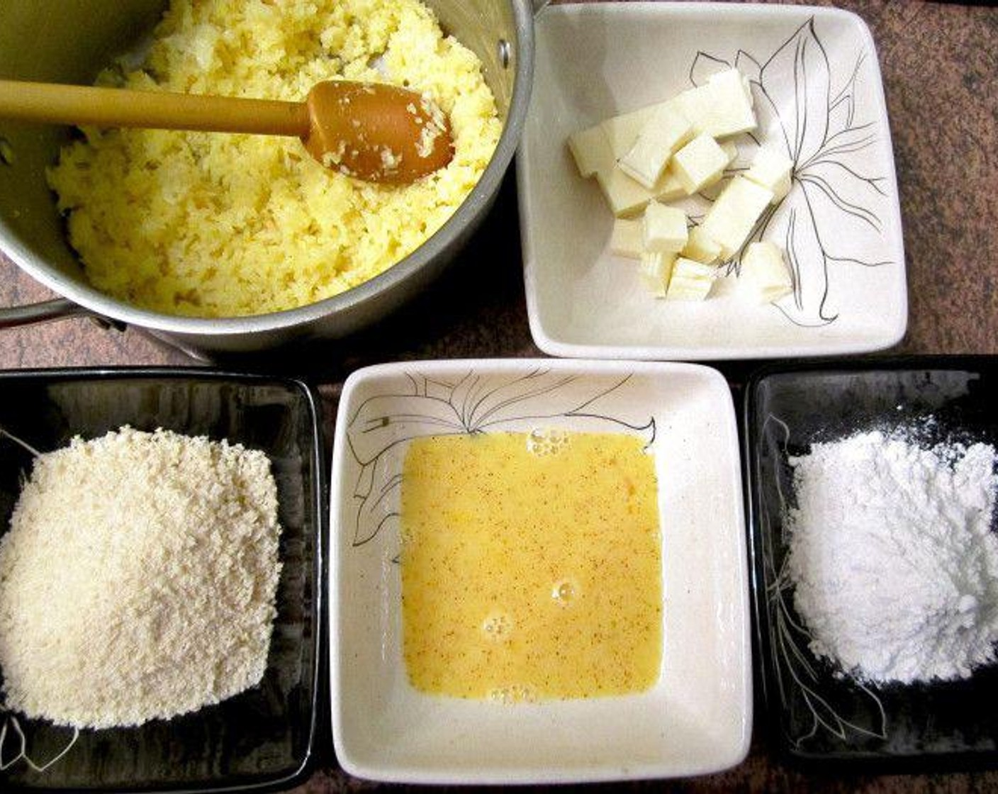 step 5 Form the rice mixture into 12 patties. Press each into one hand, add Bocconcini (12 pieces) and close the disk. Roll between two hands to form even balls. Then evenly coat each ball in the whisked egg, All-Purpose Flour (1/2 cup) and then Breadcrumbs (1/2 cup)