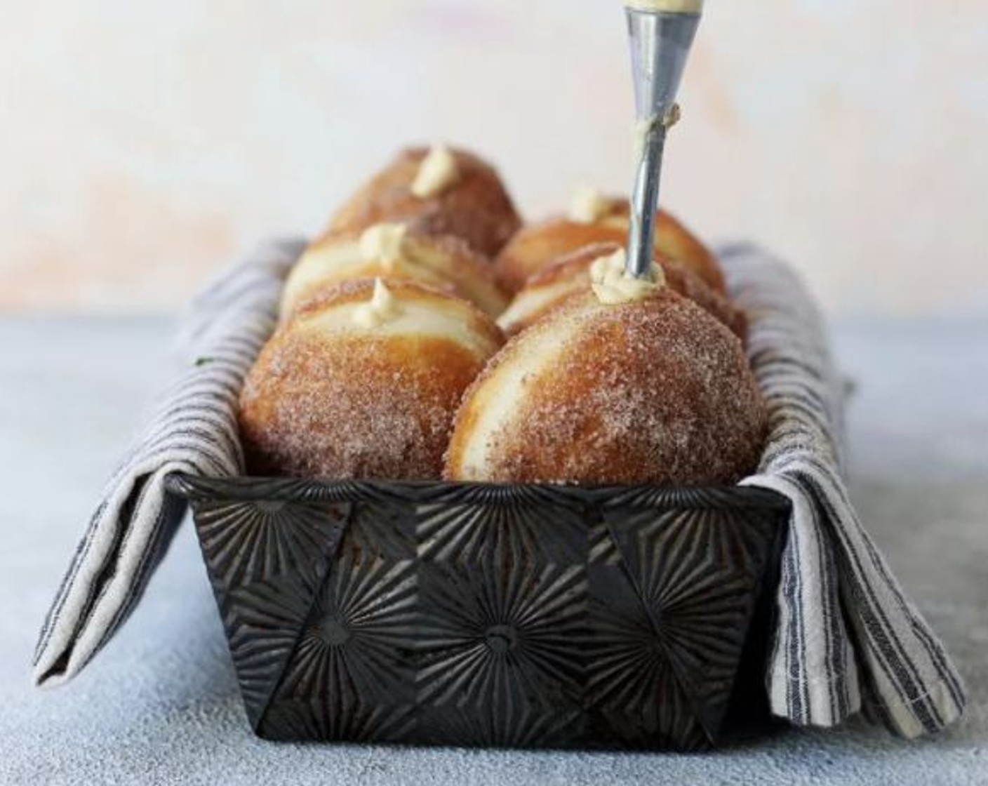 step 9 Place in a pastry bag with a filler tip and fill donuts with about 1/4 cup of filling each.