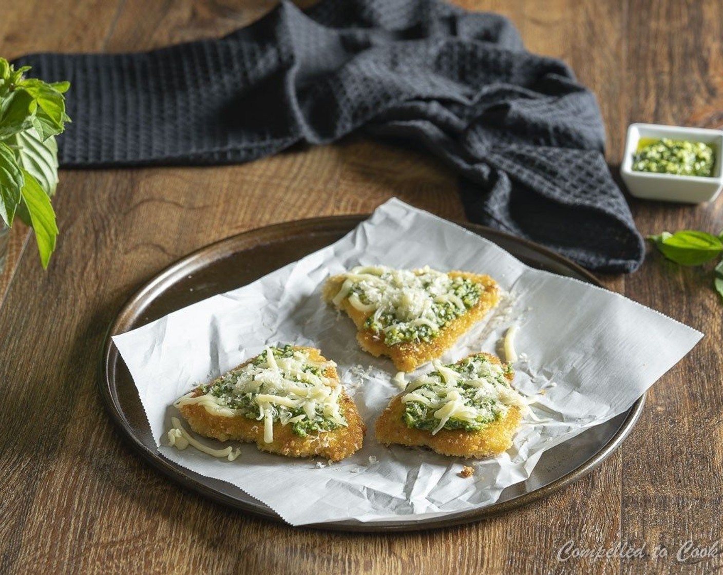 step 8 Arrange cutlets on a foil lined tray. Spread 1 tablspoon of pesto onto each cutlet and sprinkle lightly with Parmesan Cheese (1/4 cup). Broil for 1 to 2 minutes, until cheese is bubbly.