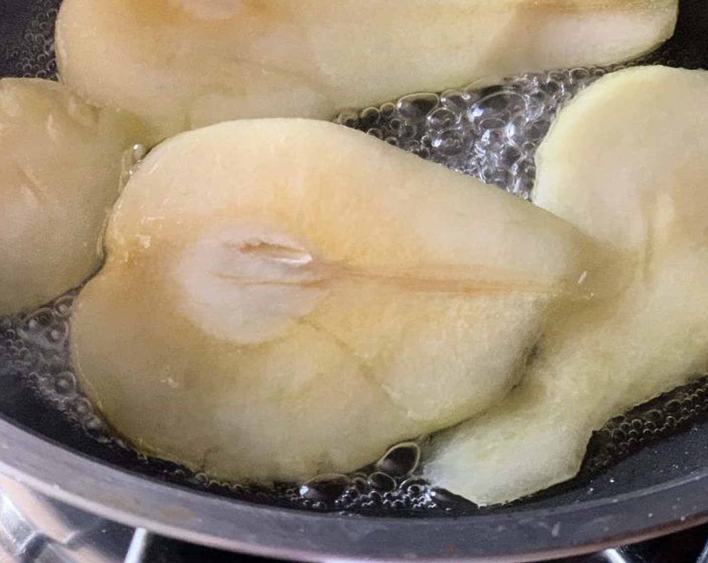 step 5 Peal and slice up the Pear (1). Place the slices in a skillet with Granulated Sugar (2 Tbsp) and Water (3 Tbsp) and cook on medium-high until it lightly caramelizes.