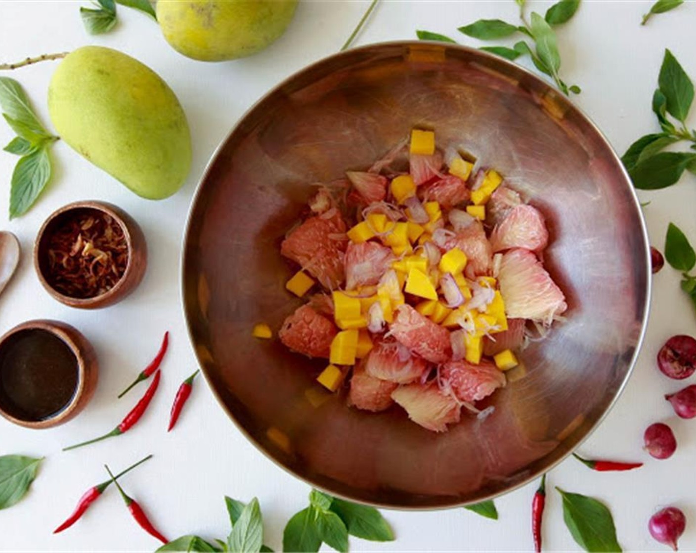 step 5 Wash and pick all the leaves off the Fresh Thai Basil (2 sprigs). Place the Pomelo (2 cups), ripe but firm mango, basil, half the fried eschallots, and the raw eschallots in a mixing bowl.