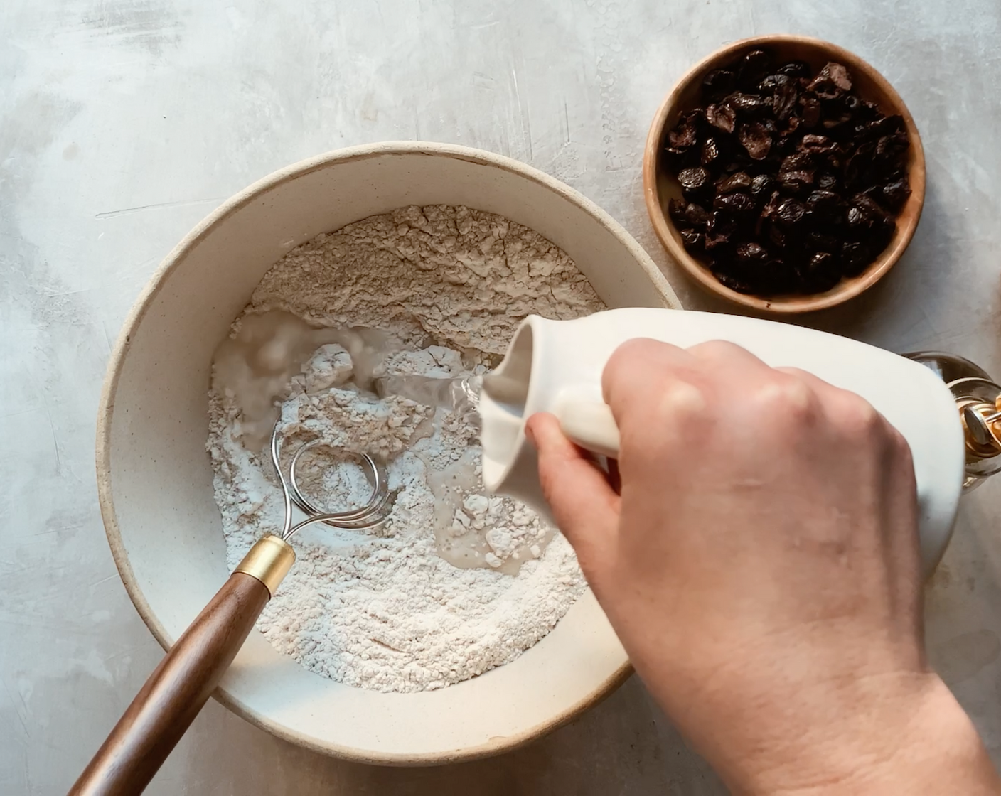 step 2 Add in the Water (2 cups) and Olive Oil (1 Tbsp) and stir until a shaggy dough has formed. The dough may seem wet at this stage, but trust the process, it will firm up a bit during fermentation.