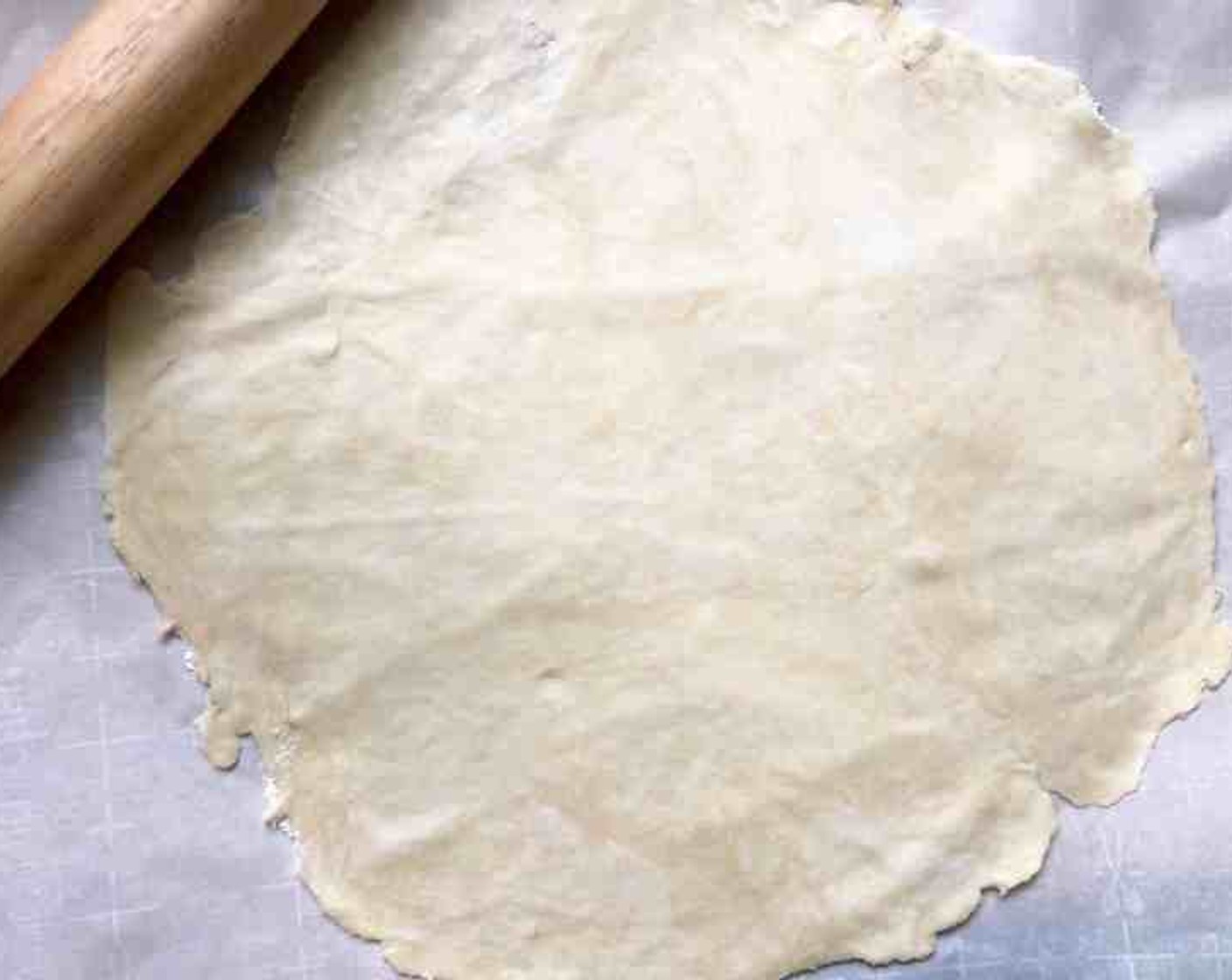 step 4 On a large piece of lightly floured parchment paper, roll pastry into a 13-inch circle. Slide the paper with the pastry onto a baking sheet. Set aside.