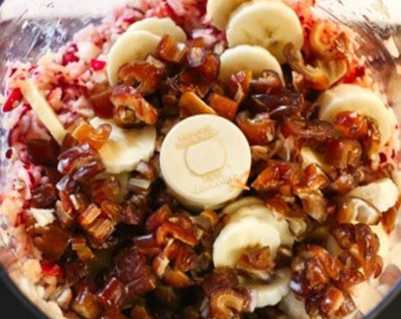 step 2 Place Gala Apples (2) and Fresh Cranberries (2 cups) in a food processor and mix until well chopped. Add the Pitted Dates (1 cup), Banana (1), Vanilla Extract (2 tsp), Unsweetened Vanilla Almond Milk (1 1/2 cups), Arrowroot Starch (1 tsp), Water (4 Tbsp), and blend for about 2 minutes until mixture is as smooth as possible.
