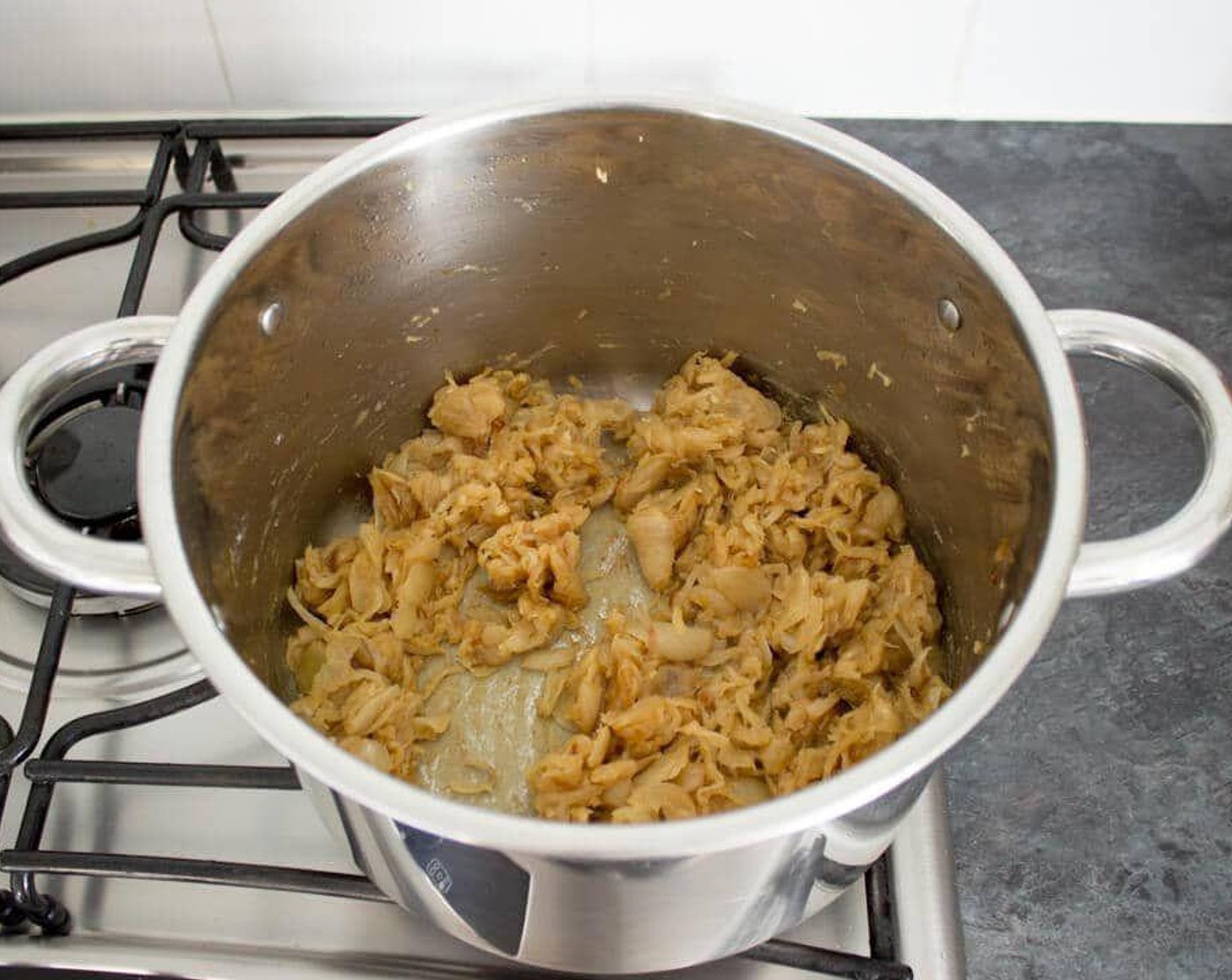 step 3 Once the onions are done, add in the Garlic (2 cloves) and All-Purpose Flour (1/3 cup) and stir continuously for about two minutes.