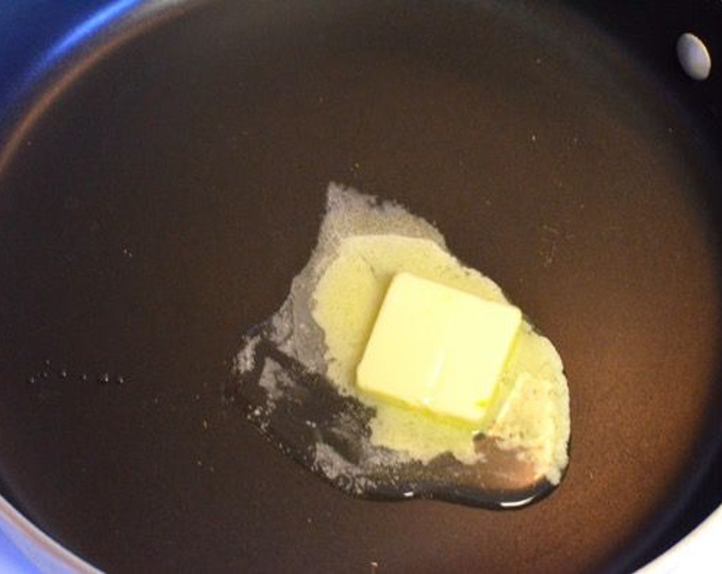 step 6 While the chicken is cooking, you can prepare the sauce. Start by melting Butter (2 Tbsp)  a skillet or a deep fry pan.