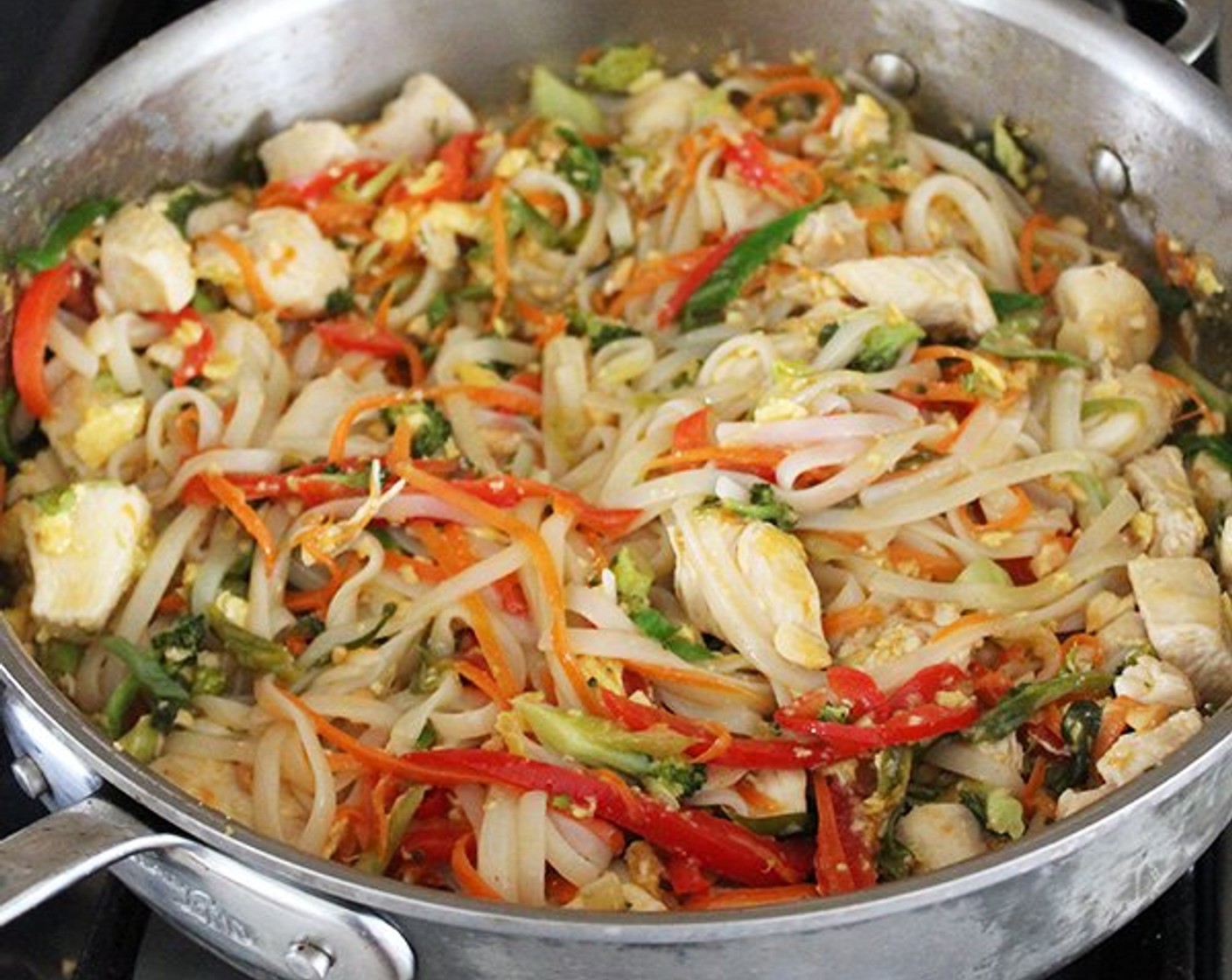 step 7 Return the chicken to the pan, along with the cooked noodles, about 3/4 of the sauce, the Bean Sprouts (1 cup), and Dry Roasted, Unsalted Peanuts (1/3 cup). Cook over medium-low heat for a few minutes, tossing until the sauce is slightly thickened and absorbed by the noodles.