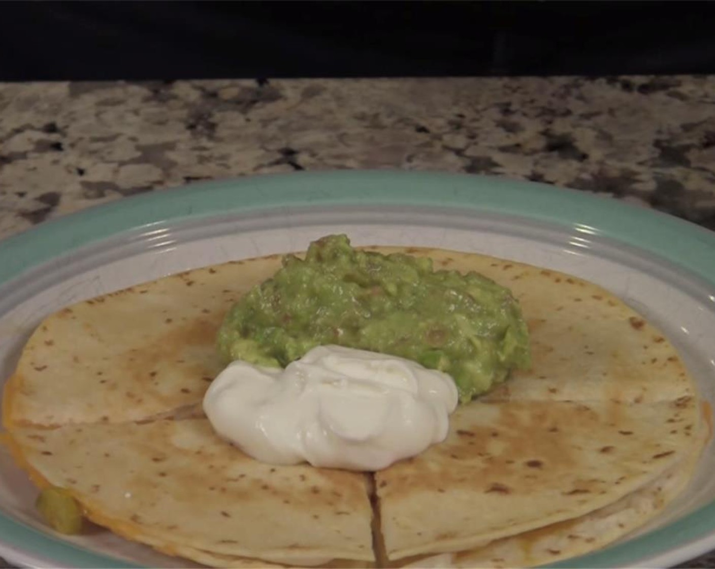 step 5 Let cook until cheese is fully melted, and bottom is nicely browned. Remove from pan, cut, and serve with Sour Cream (to taste) and Guacamole (to taste).