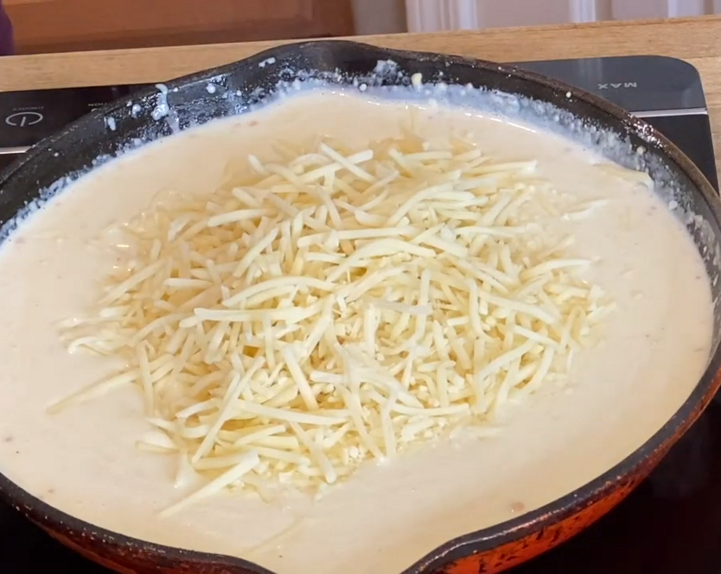 step 8 Reduce the heat to low and add Shredded White Cheddar Cheese (2 cups). Stir until melted.