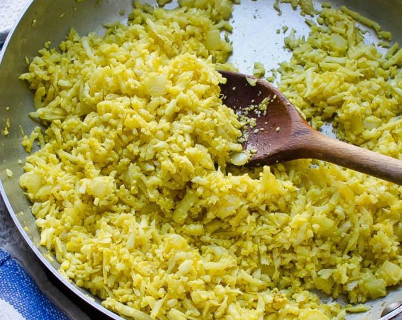 step 4 Add the cauliflower and the remaining Olive Oil (1 1/2 Tbsp) and and stir until well coated. Turn the heat down to a medium low and cover tightly with a lid. Cook for seven to ten minutes, stirring every minute or so to prevent browning or sticking. Remove from heat.