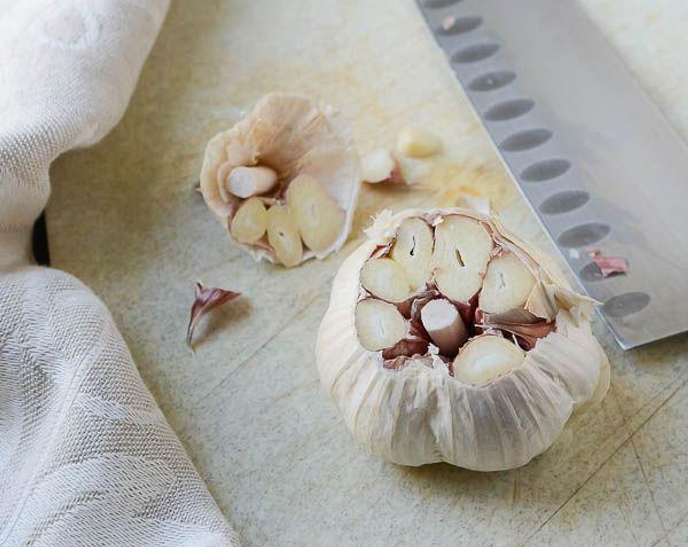 step 2 Cut the head of Garlic (1 head) crosswise at the pointy end, trimming about 1/4-1/2 inch so that the interior of the cloves are exposed.