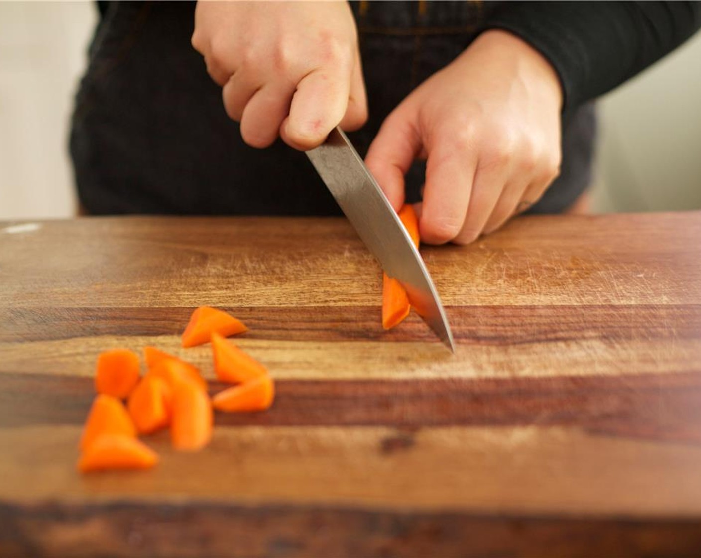 step 6 Peel and slice the Carrot (1) into one inch pieces by cutting across and then slice on the bias. Repeat this process for the whole carrot. This is called a roll cut. Set carrot aside.