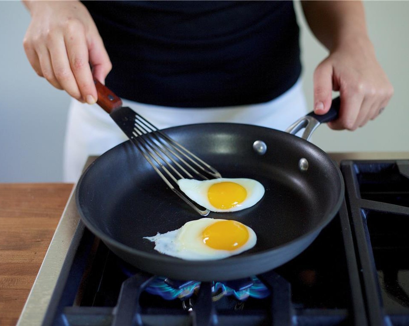 step 11 In a medium non stick pan, heat Vegetable Oil (1 Tbsp) over medium low heat. Carefully crack the Eggs (2) into the pan next to one another, but not touching. Do not break the yolks!