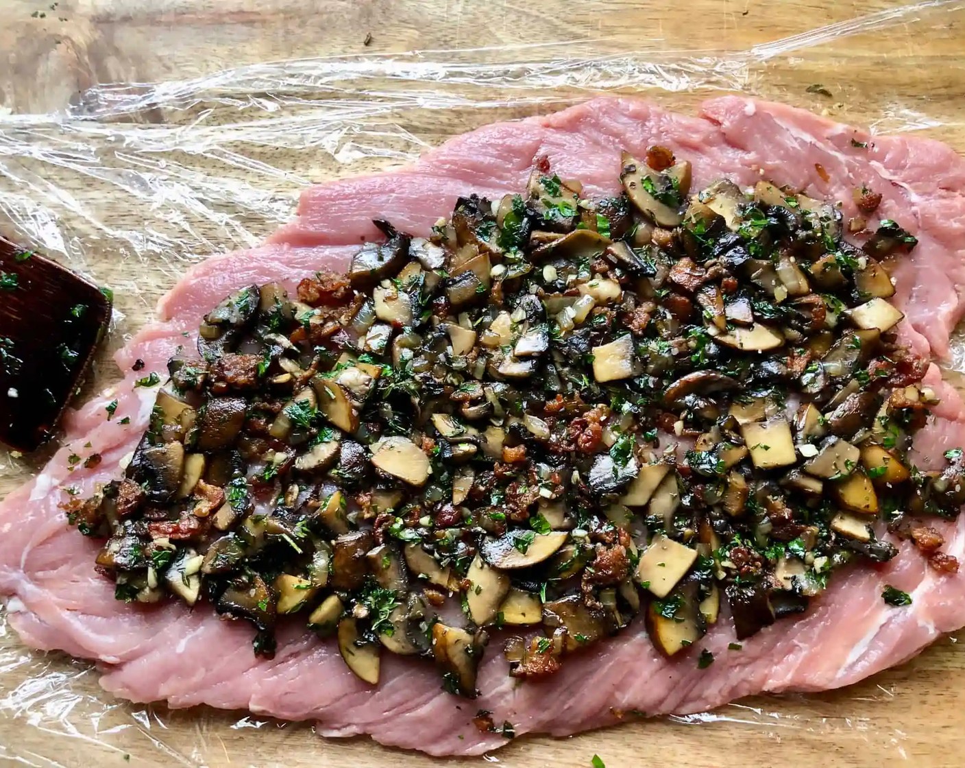 step 8 Stuff the Pork Tenderloin: Spread the mushroom mixture evenly over the surface of the meat, leaving about a 1/2-inch border all around.