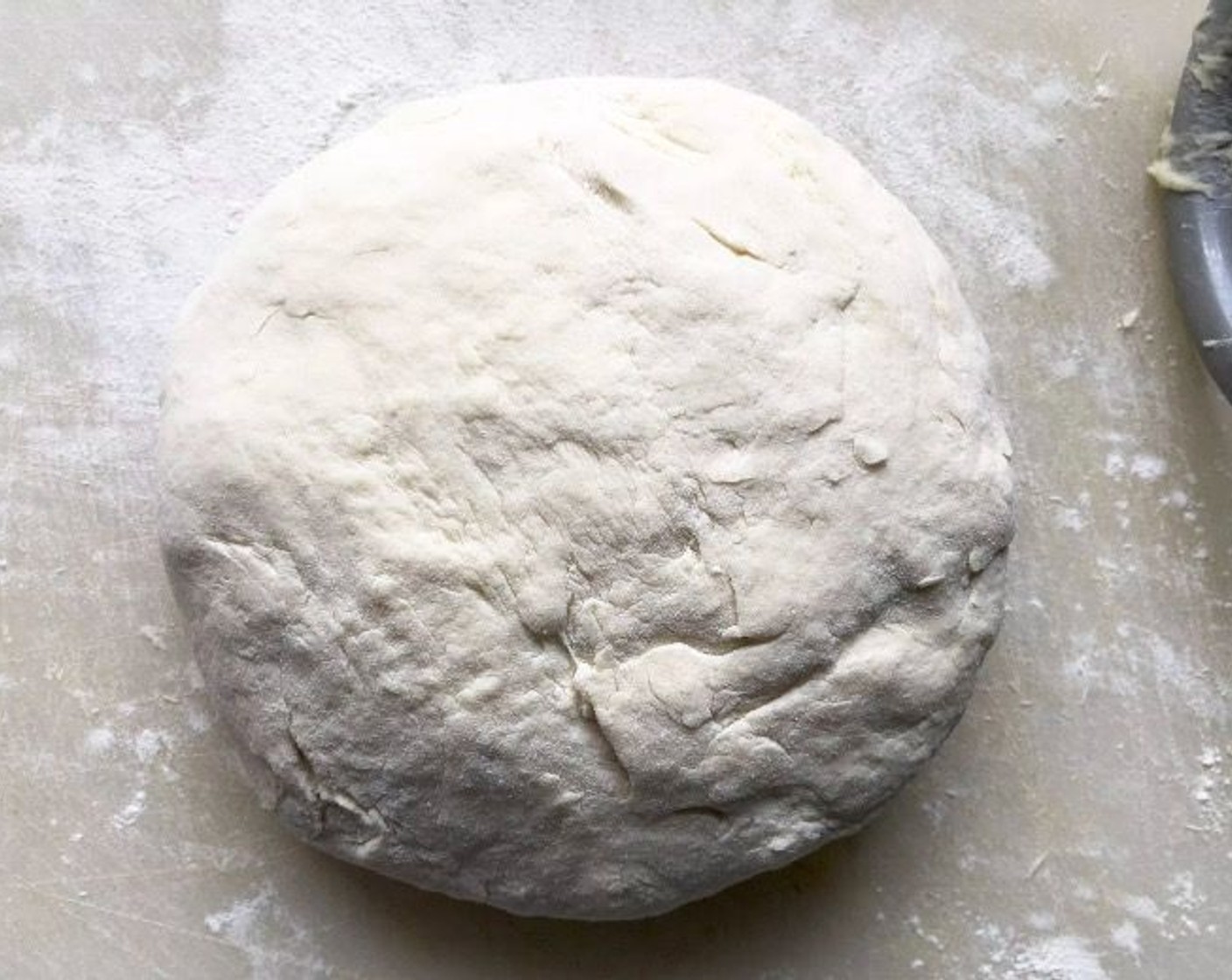 step 5 Dust dough lightly with flour and remove from the bowl. With floured hands, knead the dough into a ball.