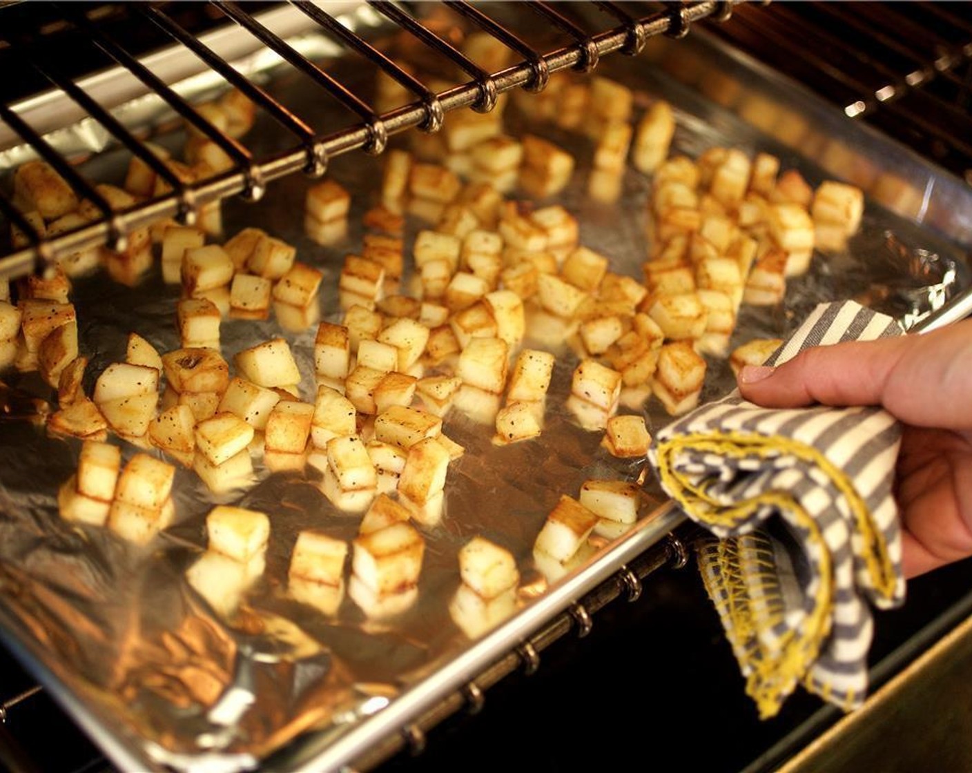 step 4 Place potatoes on a sheet pan lined with foil and bake for 15 minutes.