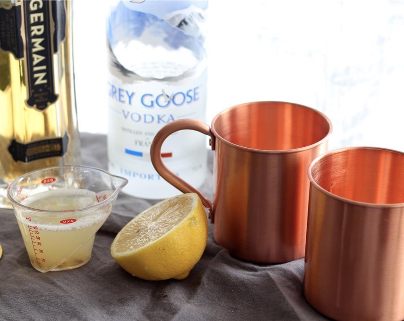 step 2 In a mule mug, combine the GREY GOOSE® Vodka (2 fl oz), ST. GERMAIN (0.8 fl oz) and the juice from Lemon (1).