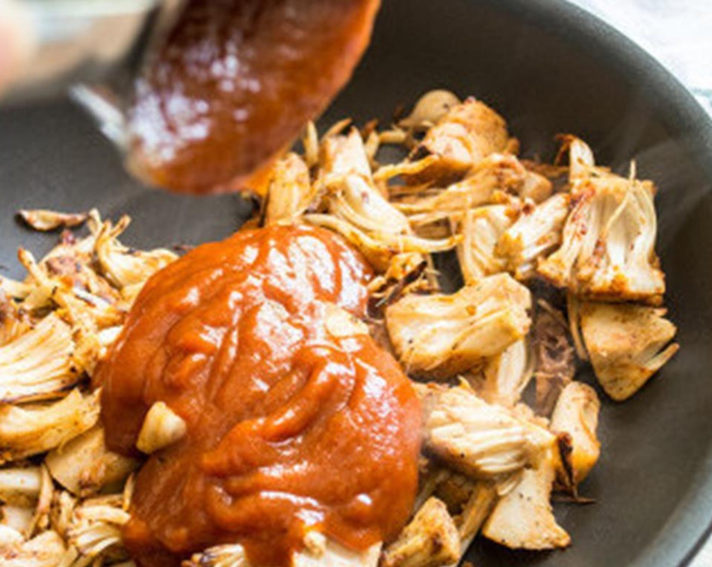 step 3 Add Coconut Oil (1/2 Tbsp) and seasoned jackfruit to pan and cook on medium-heat for 4-5 minutes, or until jackfruit begins to color.