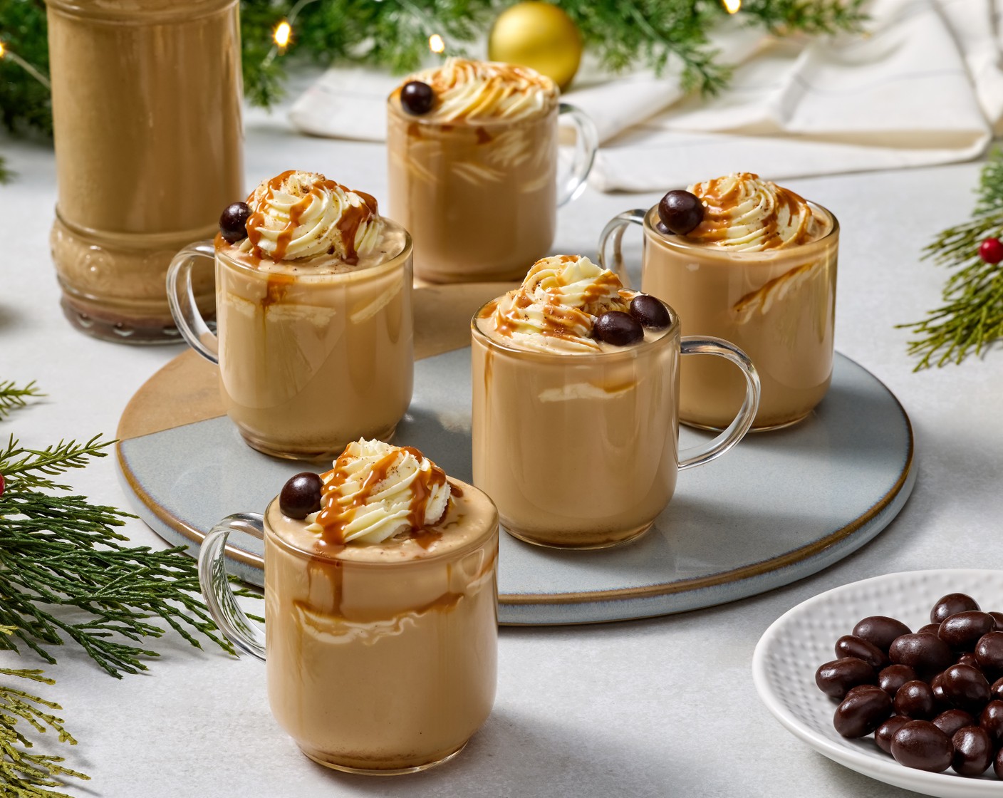 step 4 To serve, transfer Whipped Cream (to taste) to a piping bag fitted with a star tip. Stir or shake the bottle of coquito well to recombine. Pour the coquito into serving glasses, pipe whipped cream on top, and dust with additional nutmeg. Drizzle with Dulce de Leche (1 bottle) and garnish with Dark Chocolate Covered Espresso Beans (to taste). Serve and enjoy!