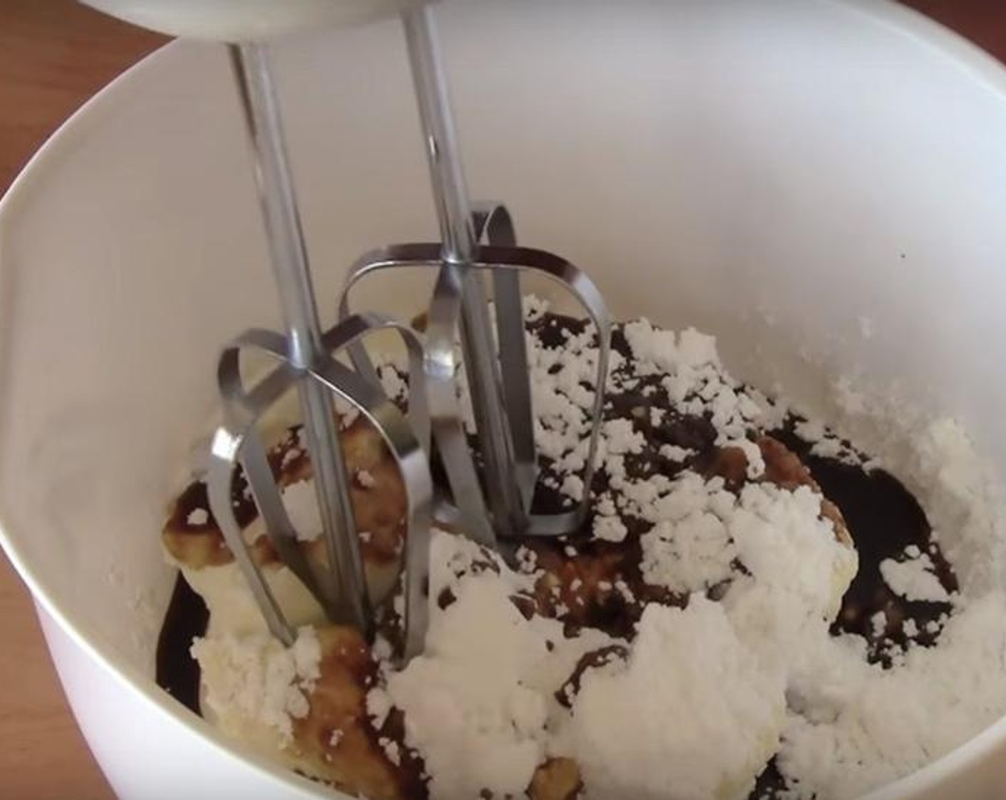 step 4 For the frosting: put Cream Cheese (1 cup) into a bowl. Add in Powdered Confectioners Sugar (1/2 cup) and Instant Coffee (2 tsp) dissolved in a little bit of warm water. Beat them together.