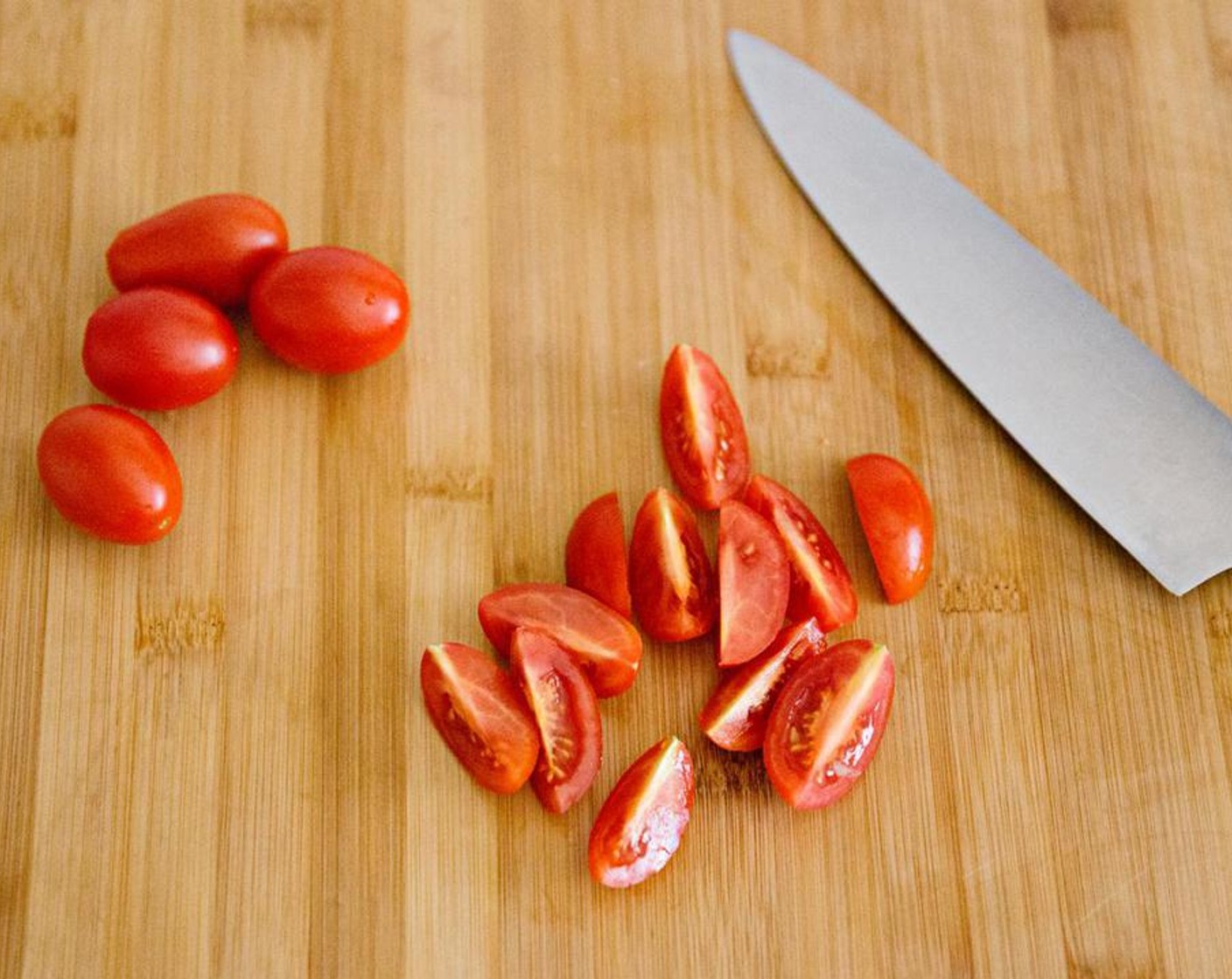 step 3 Cut the Cherry Tomatoes (8) into quarters.