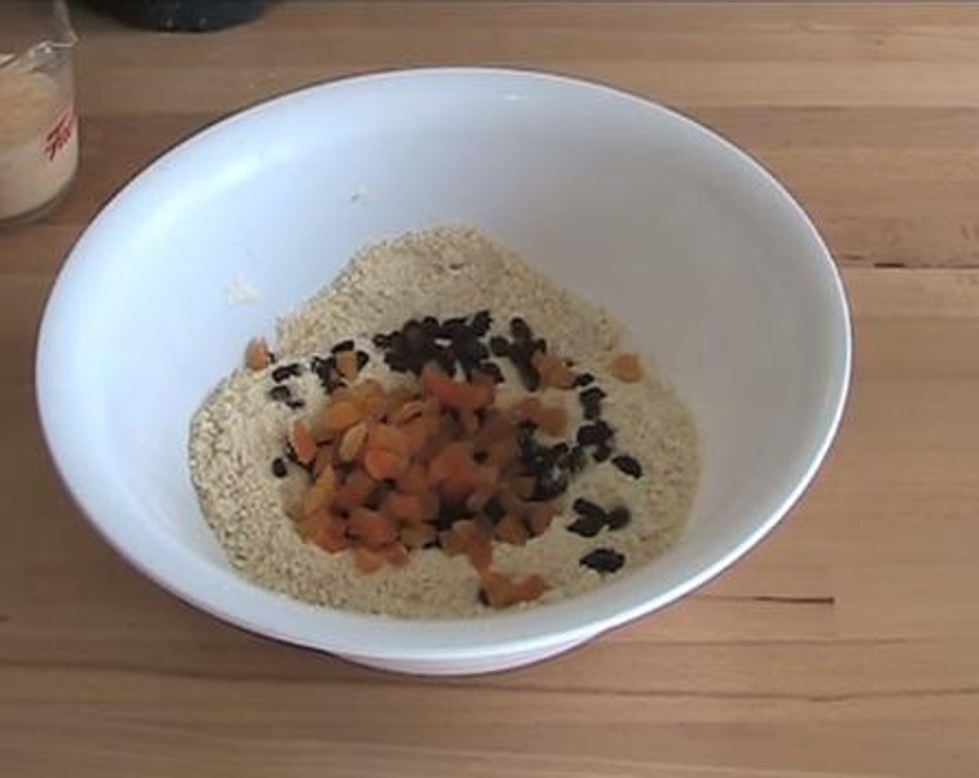 step 2 Into a mixing bowl, add and mix the Self-Rising Flour (2 cups), Simply Organic Cinnamon, Ground (1/2 tsp), Caster Sugar (1/3 cup) and Butter (3.5 oz). Then add in the Sultanas (1/2 cup), and Dried Apricot (1/2 cup).