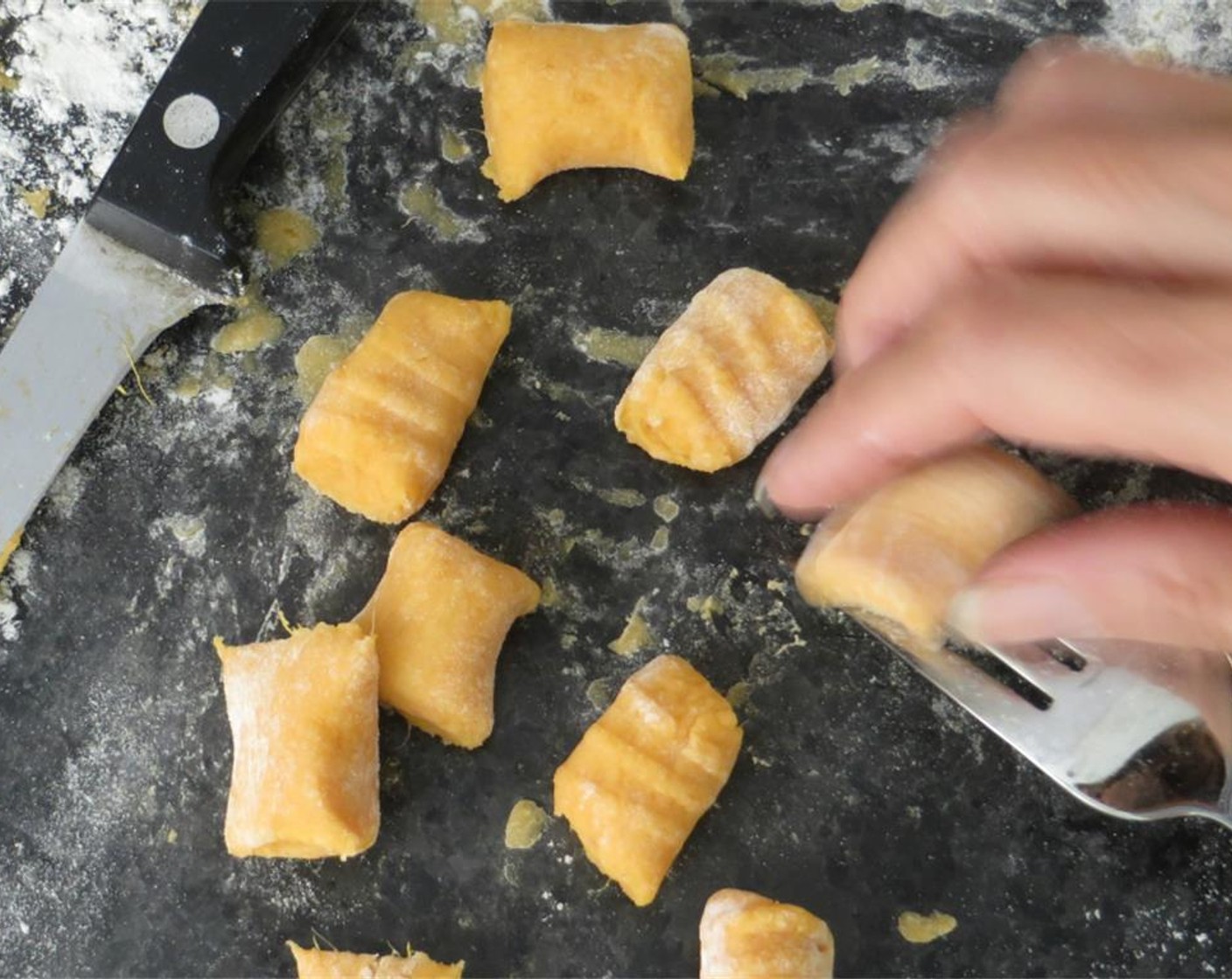 step 9 Use a sharp knife to cut 1-inch segments. Use a fork, tines facing down, to make the ridges. Hold one of the gnocchi and gently roll it from the bend in the fork, along the tines, pressing lightly. Repeat with remaining dough.