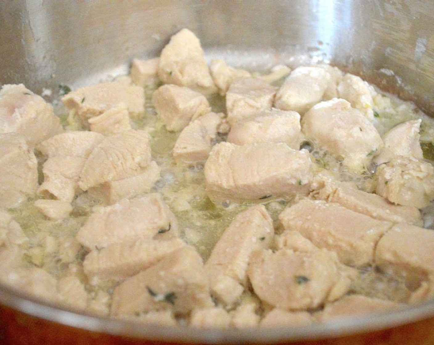 step 3 Add the Boneless, Skinless Chicken Breast (1 lb) and cook it through completely. While it cooks add the Garlic (2 cloves), Fresh Thyme (1 tsp), and Lemon (1/2) to make everything fragrant. Season it with Salt (1 pinch) and Freshly Ground Black Pepper (1 pinch). Remove to a plate and set aside.
