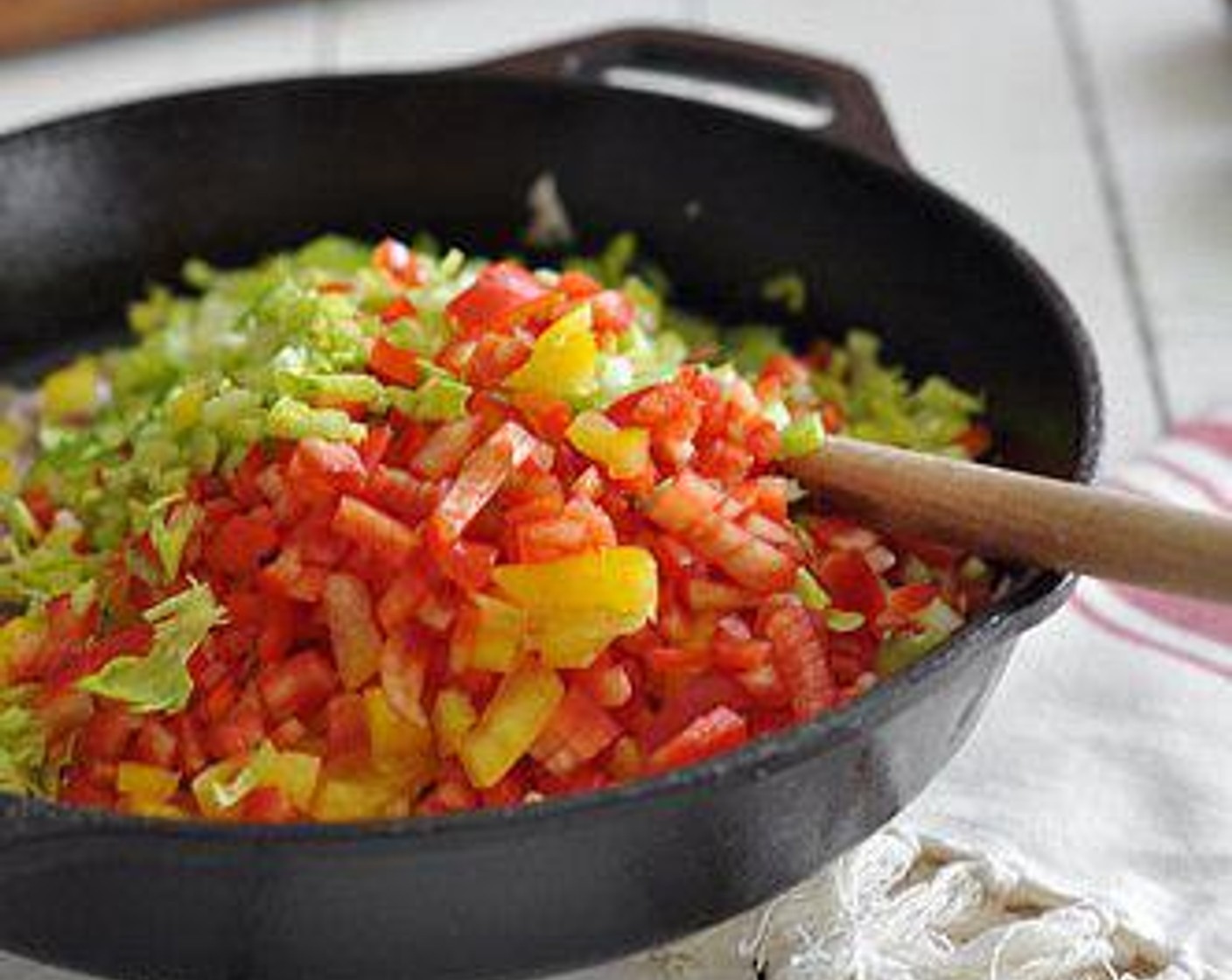 step 5 Heat a skillet over medium high heat. Add the Unsalted Butter (1/4 cup),  When melted, add the chopped small red onion, red bell pepper, yellow bell pepper, garlic cloves, celery, parsley, and caper.