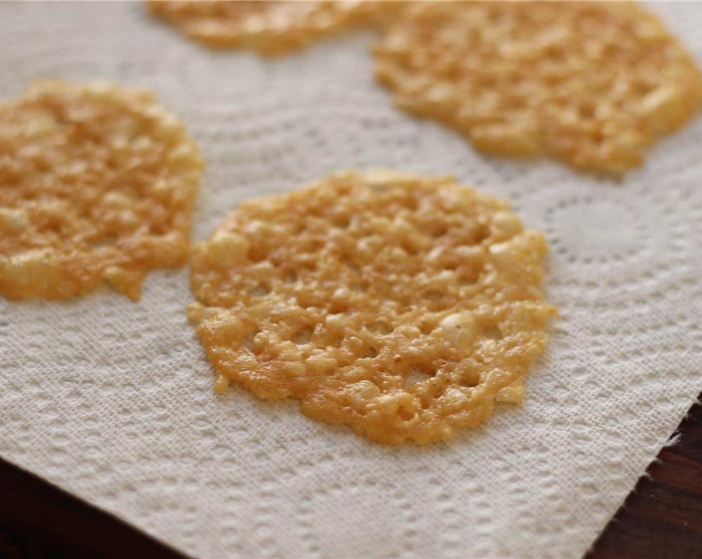 step 6 Slide the cookie sheet into the oven and bake for 4 minutes, or until crisp and golden. Transfer the crisps to a paper towel lined plate to cool and crisp up.