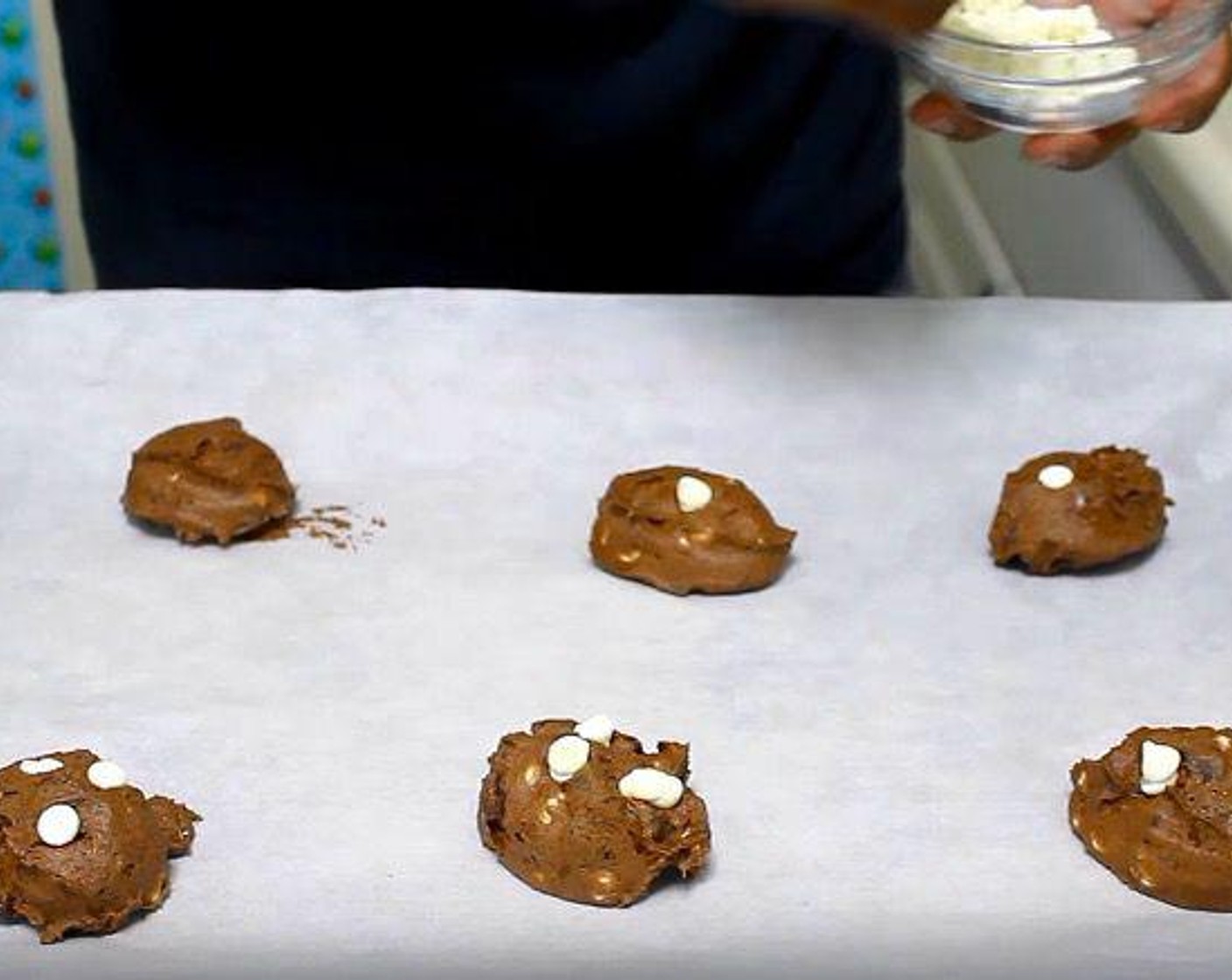 step 5 Line a baking sheet with parchment paper. Place spoonfuls of cookie dough onto the paper.