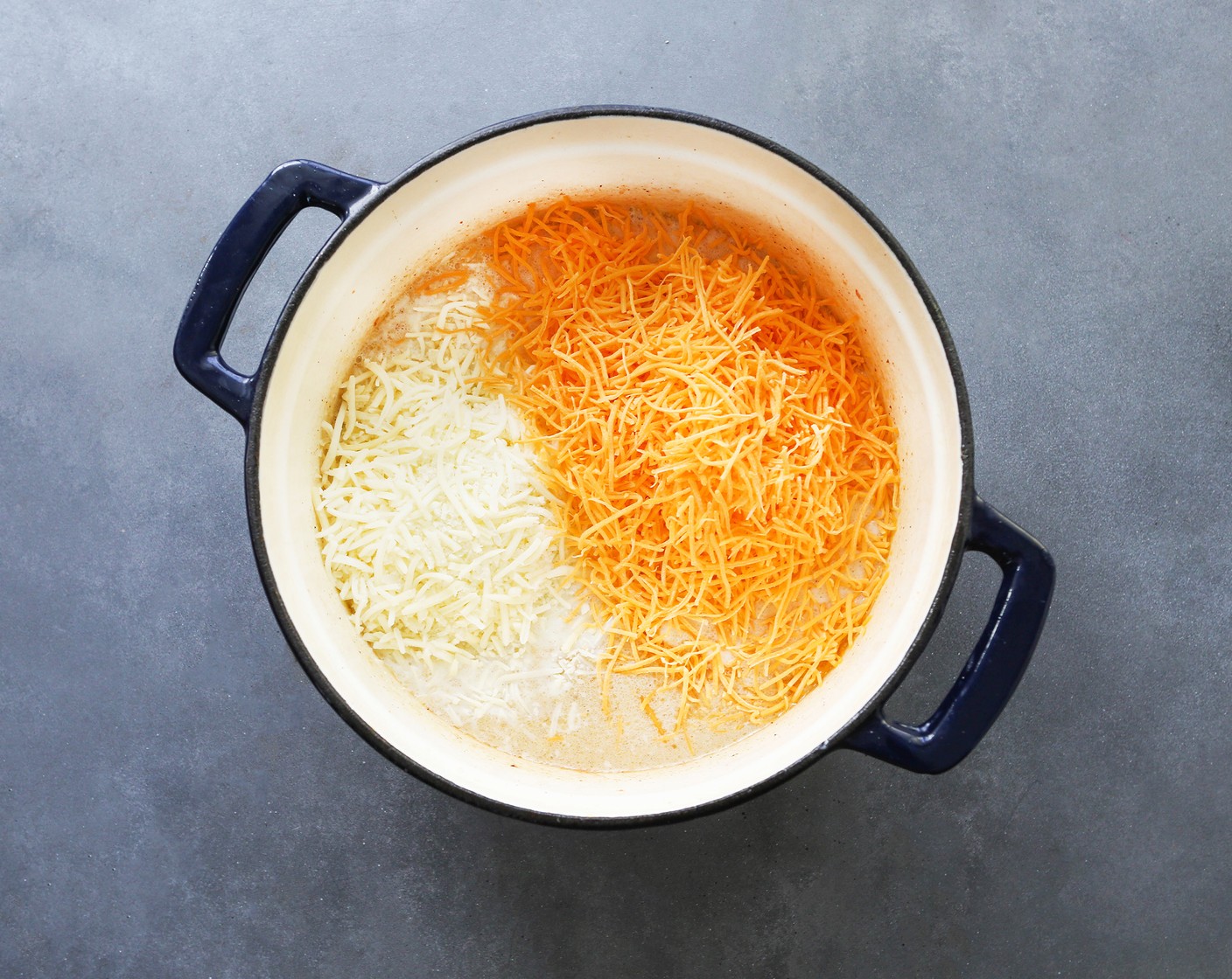 step 6 Add All-Purpose Flour (1/4 cup) and whisk until combined. Add Milk (3 cups) and whisk until mixture is creamy. Add Shredded Cheddar Cheese (2 cups), Shredded Mozzarella Cheese (2 cups), Salt (1 tsp), and Ground Black Pepper (1 tsp) and stir until cheese is melted.
