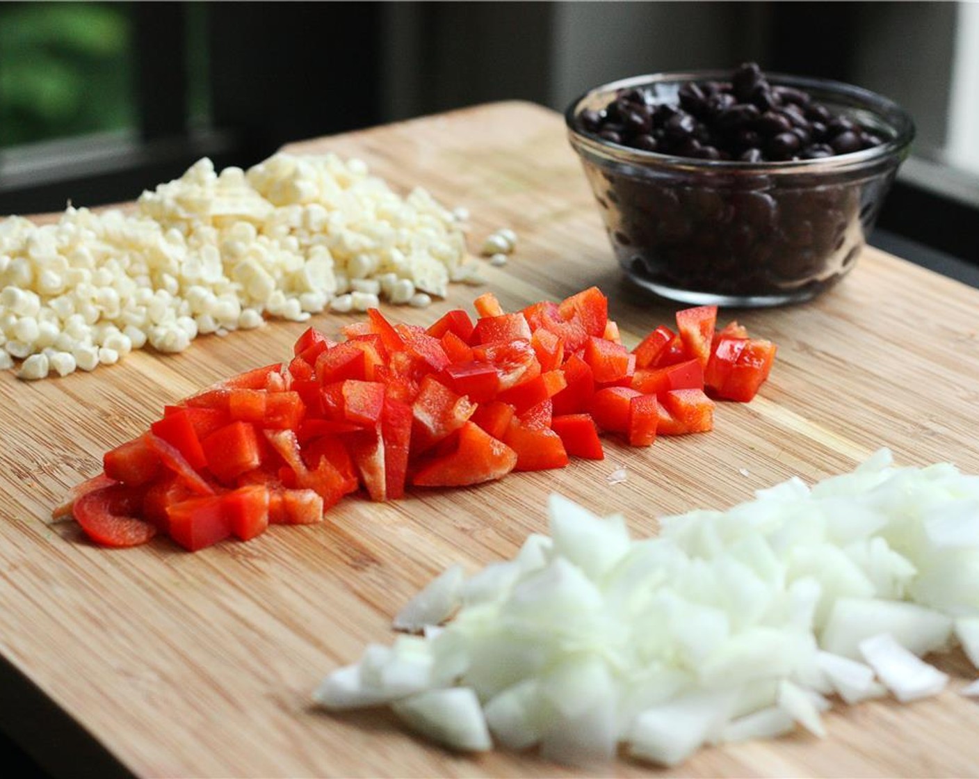 step 3 Dice the Yellow Onion (1/2) and Red Bell Pepper (1/2). Drain and rinse the Canned Black Beans (2/3 cup). Cut the Avocado (1/2) into 1″ chunks. Slice the kernels off the the Sweet Corn (2 ears).