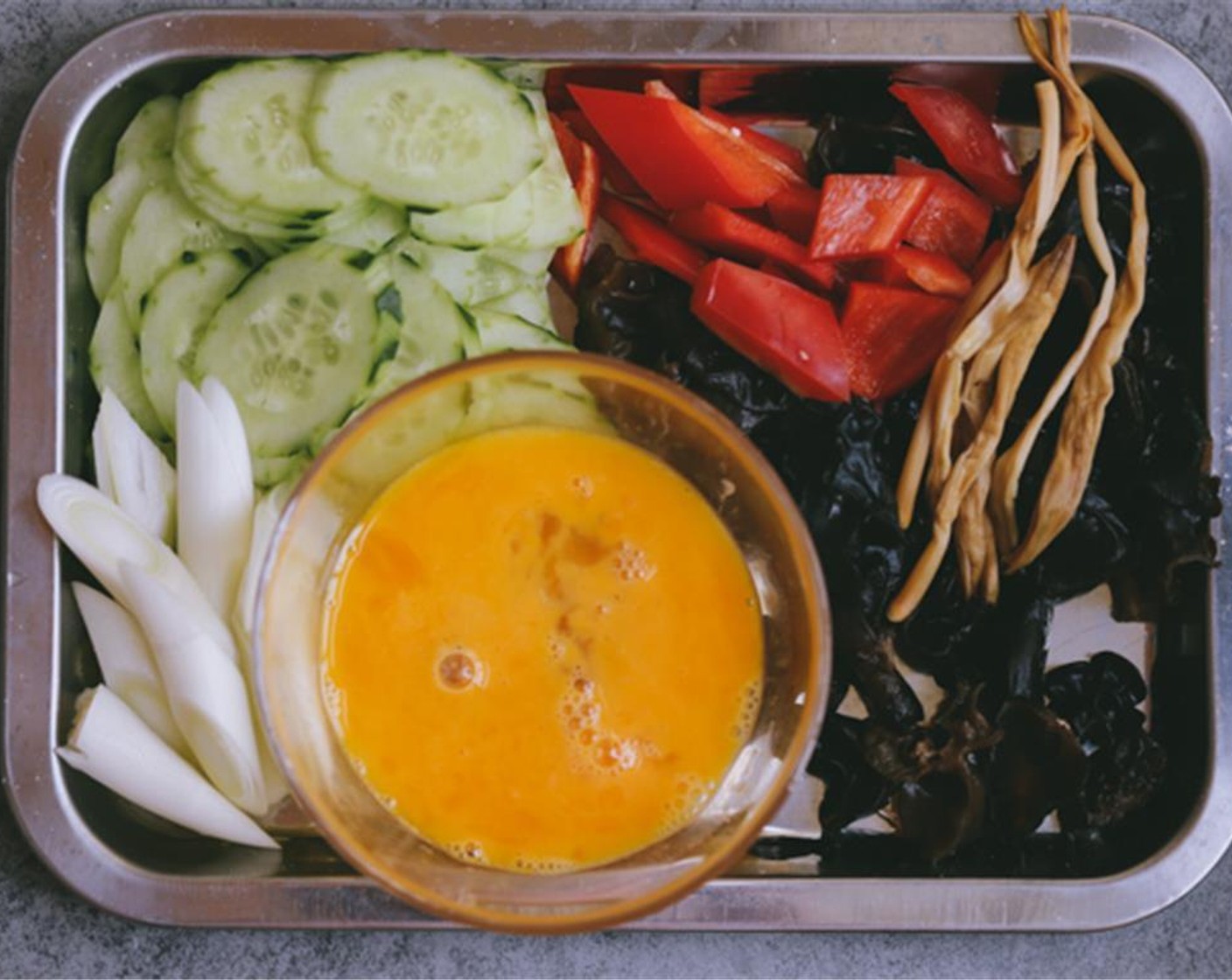 step 3 Slice the Cucumber (1/2) and the Carrot (1). Whisk the Eggland's Best Classic Eggs (2).