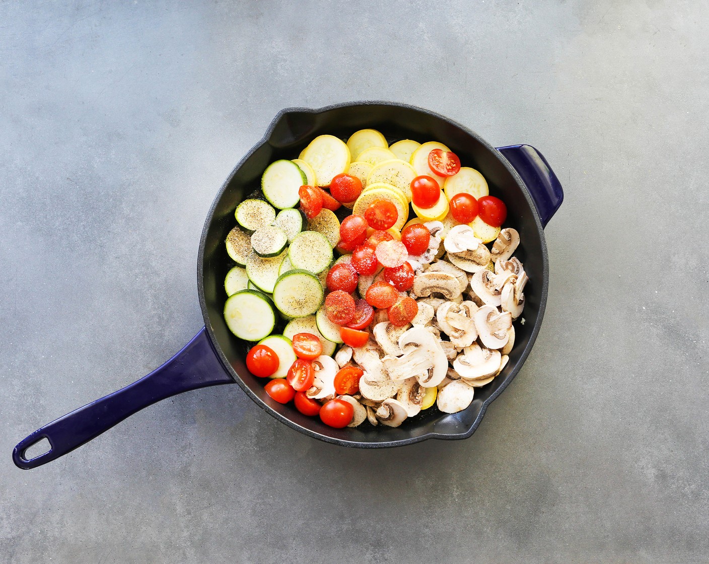 step 2 Add Zucchini (1), White Mushrooms (2 1/3 cups), Yellow Squash (1), Cherry Tomatoes (2 cups), Salt (1/2 tsp), and Ground Black Pepper (1/2 tsp) to the skillet and stir so veggies are well-coated.