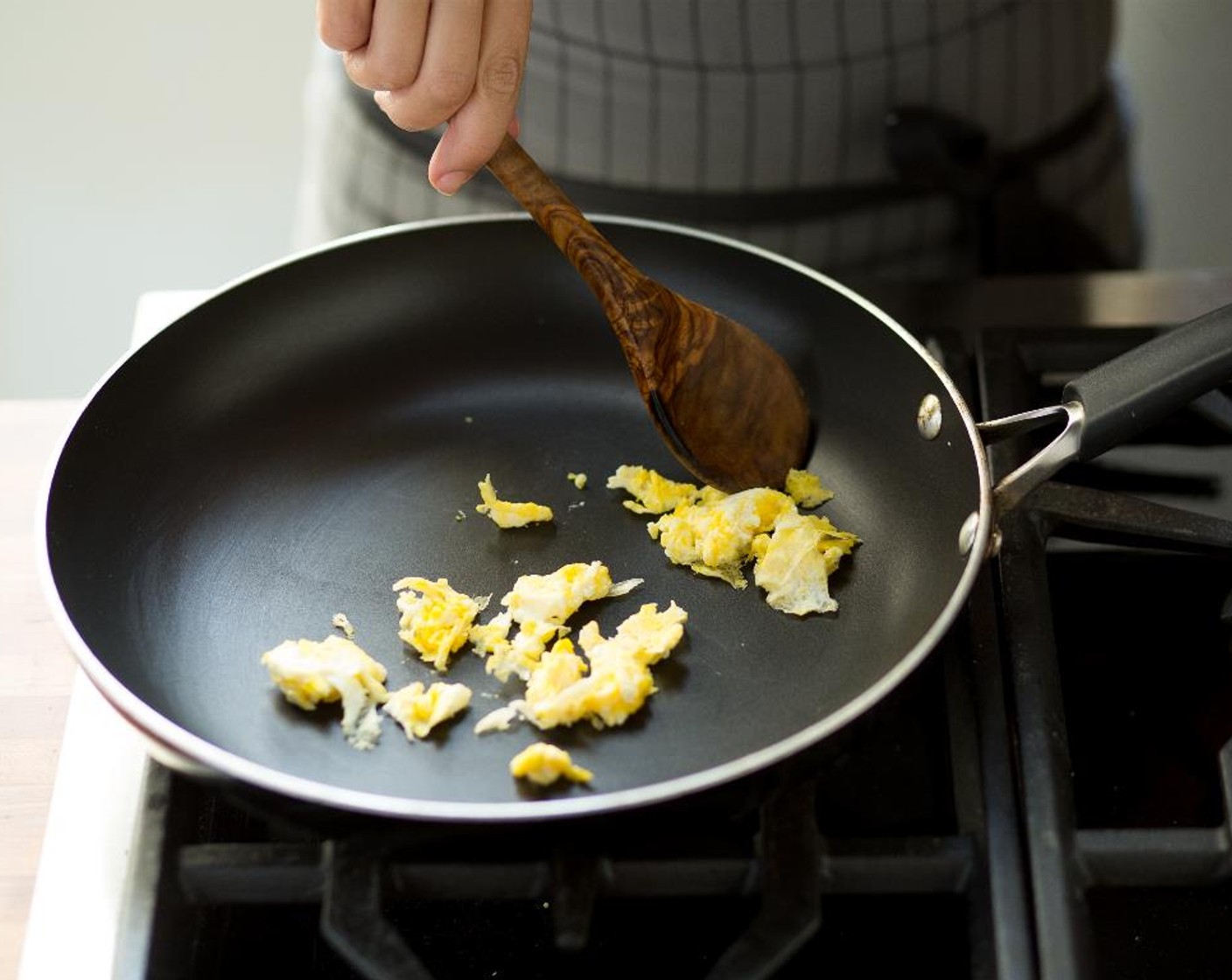step 9 Heat Canola Oil (1 Tbsp) in a large non-stick sauté pan or wok over medium-high heat. Cook the egg first and stir to scramble. When done, transfer the egg to a plate; set aside.