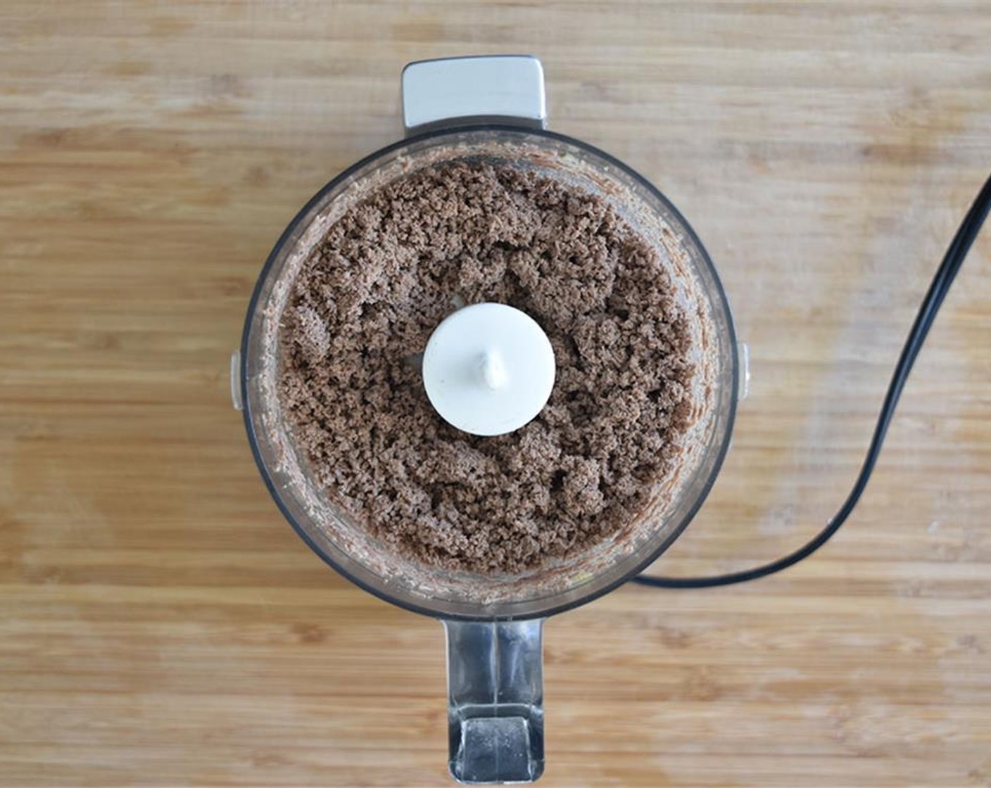 step 7 Once meat is done, place into a food processor. Process beef until it reaches the consistency you see in the picture.