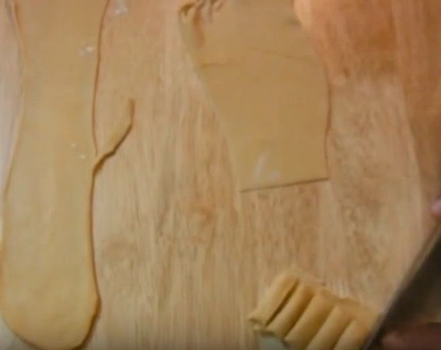 step 8 Roll the dough up halfway. Cut it horizontally, about 1/4-inch thick. After you cut the dough, unravel each piece to form fettuccine noodles.