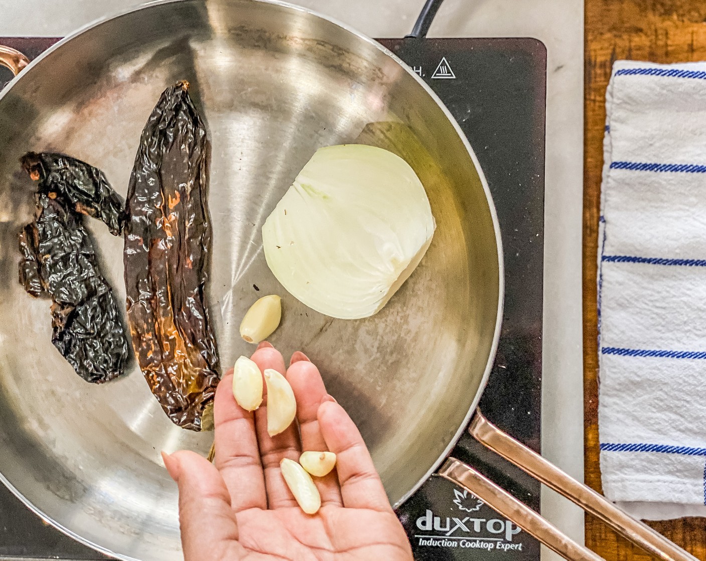 step 2 Add Onion (1/2) and Garlic (5 cloves), cook, until slightly charred, about 3 minutes each side.