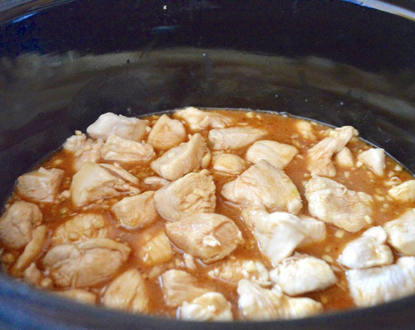 step 3 Mix the remaining Corn Starch (2 Tbsp) with the Water (1/2 cup) to create a slurry and pour it into the slow cooker with the chicken. Add the Garlic (3 cloves), Low-Sodium Soy Sauce (1/2 cup), Honey (1/3 cup), Sesame Oil (1 Tbsp), and Rice Vinegar (1/3 cup). Stir it all together and turn the heat to low. Seal the slow cooker and let it all cook for 3 hours.