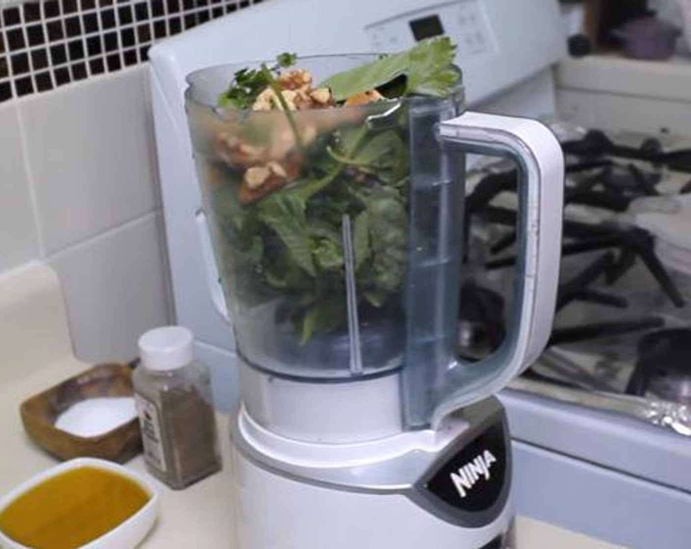step 1 In a food processor, or a blender if none are available, add the fresh Fresh Basil (3 cups), fresh Fresh Parsley (1 cup), Walnut (1/4 cup), Garlic (3 cloves), and Grated Parmesan Cheese (1/4 cup). Zest and juice the Lemon (1) into the processor and turn it on.