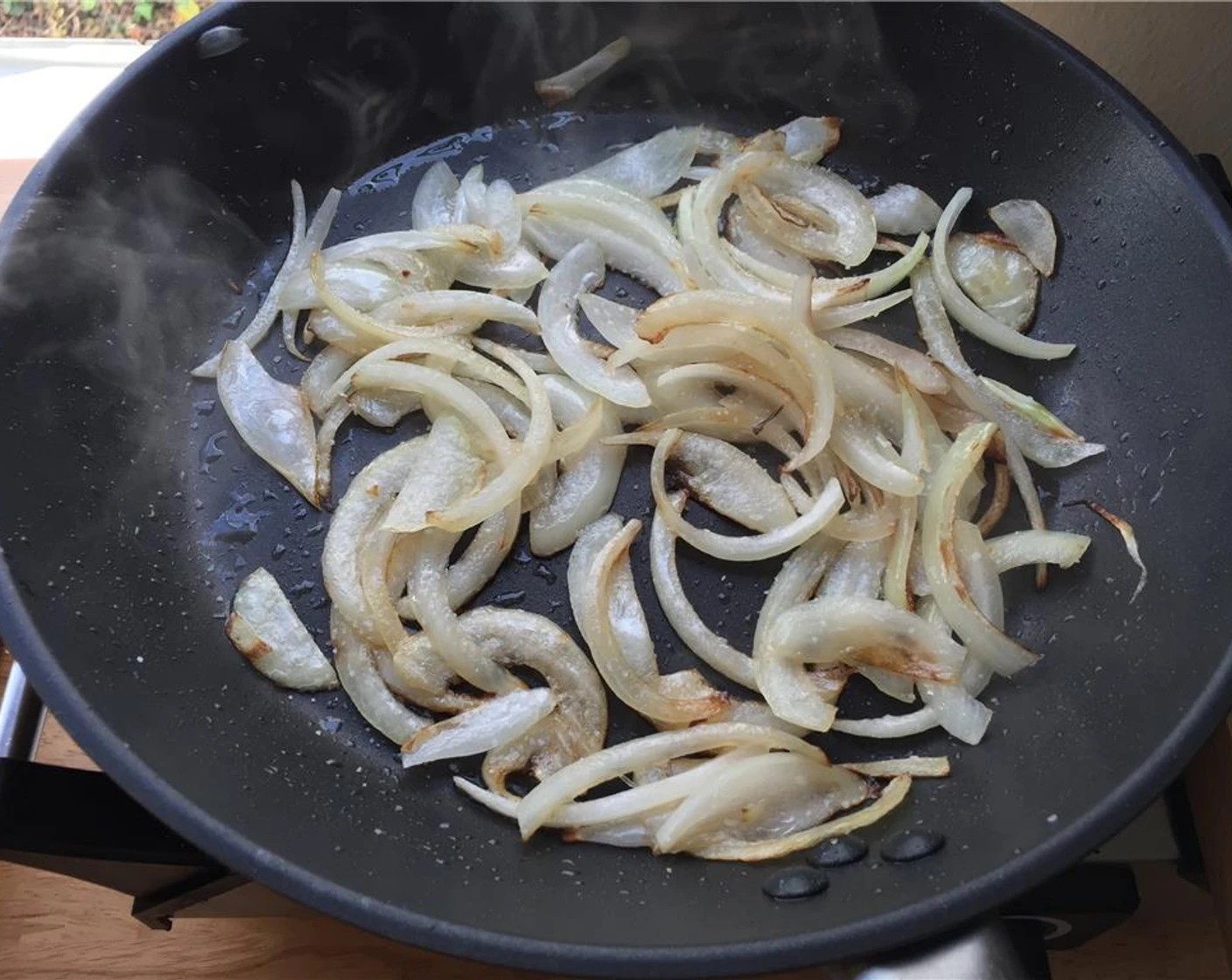 step 2 To a saute pan over medium-high heat, add the Olive Oil (1 tsp), and once shimmering, add the sliced onion. Toss a few times for 4 to 5 minutes to get some color on them. If the pan seems too hot, lower to medium.