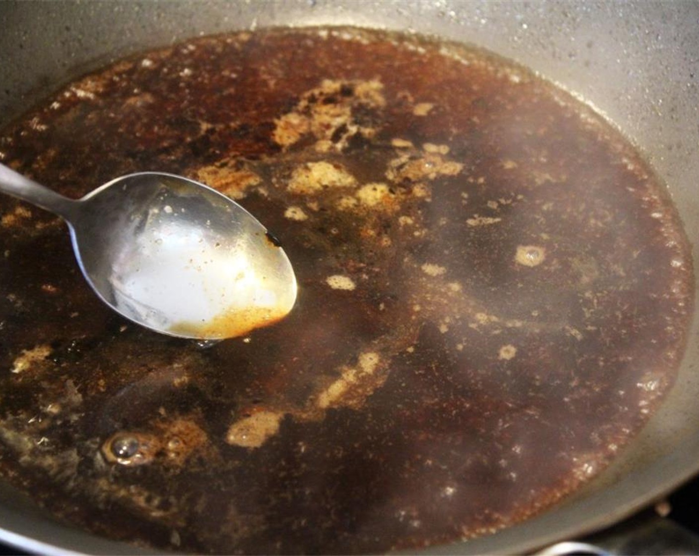 step 7 In the same hot pan, add any leftover steak sauce and the Beef Broth (1/2 cup). Stir to combine and deglaze the pan, then turn off the heat.